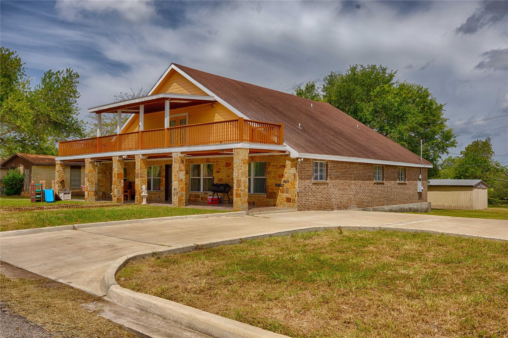 Stone and brick masonry elements define this mult