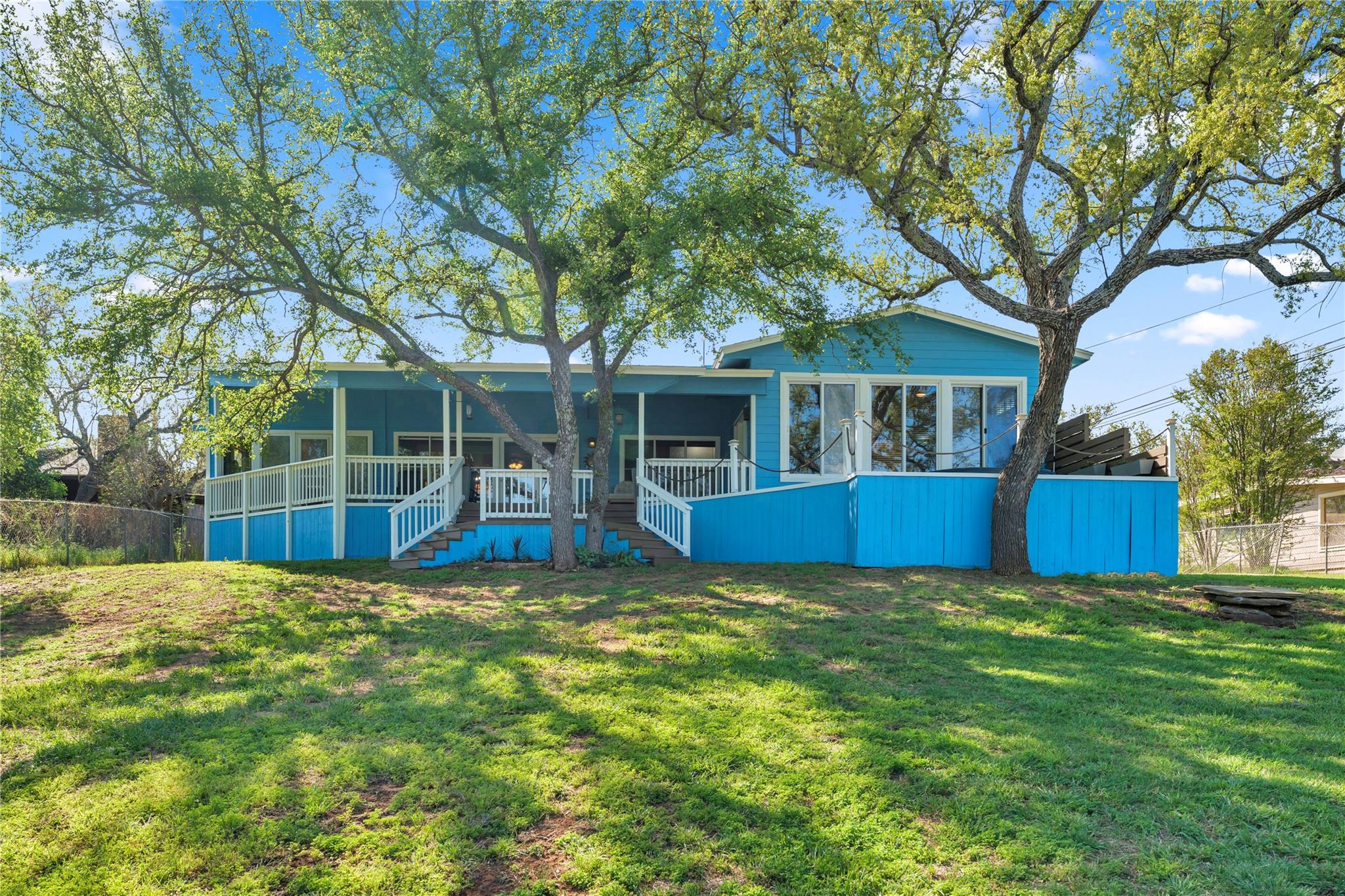 Mature trees shade the spacious backyard borderin