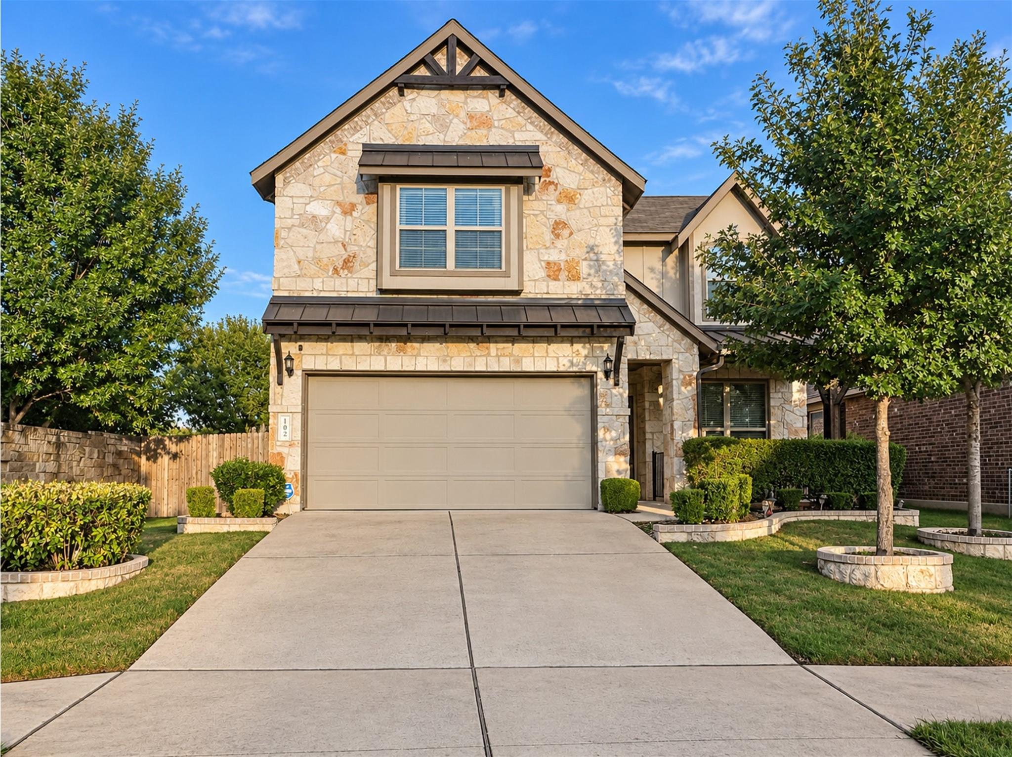 Natural stone masonry and a concrete driveway def