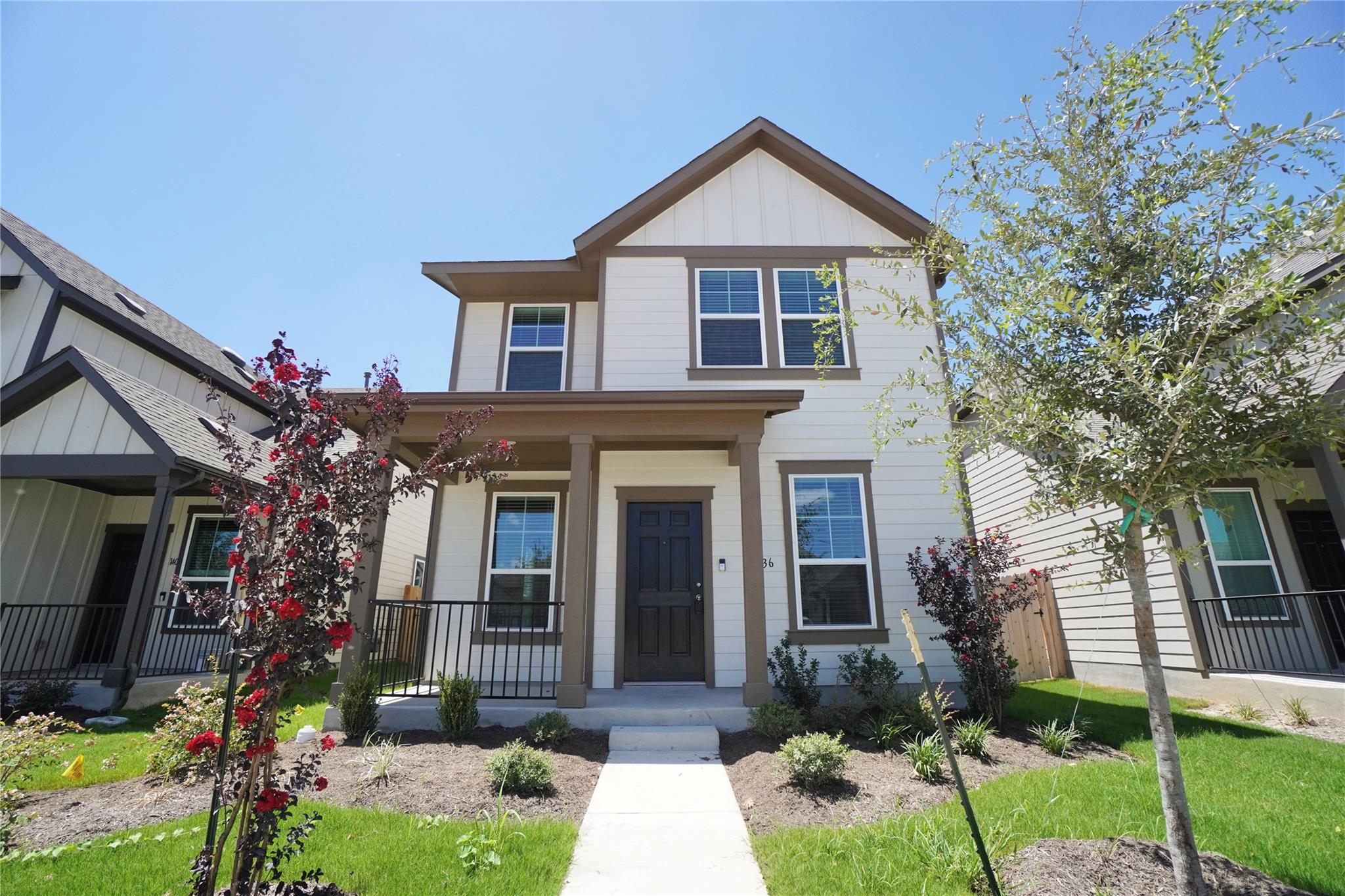 Symmetrical two-story facade with crisp siding, p