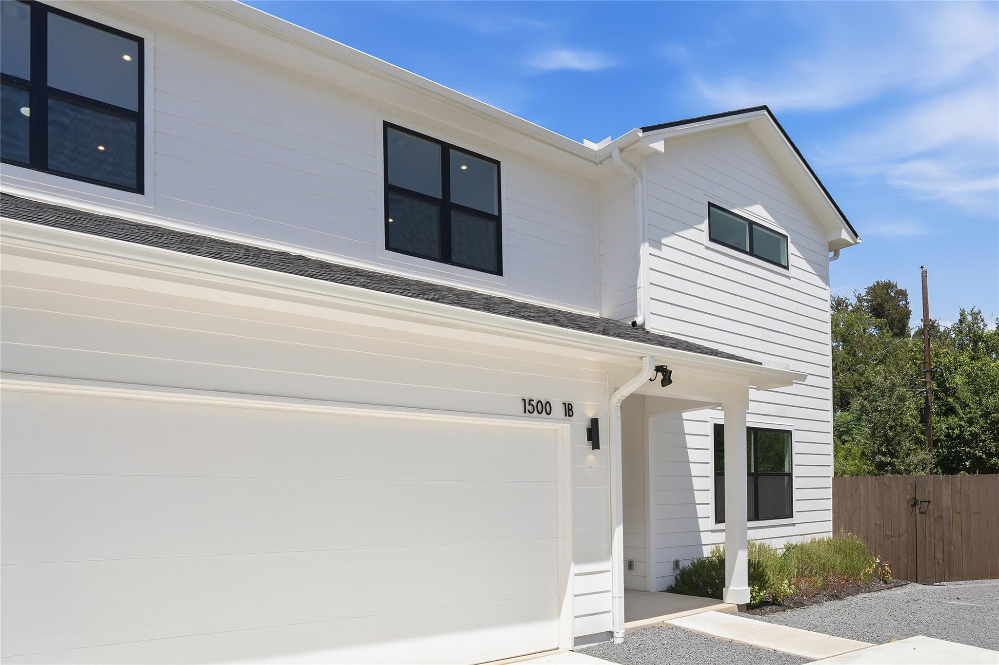 Clean horizontal siding and dark-trimmed windows 