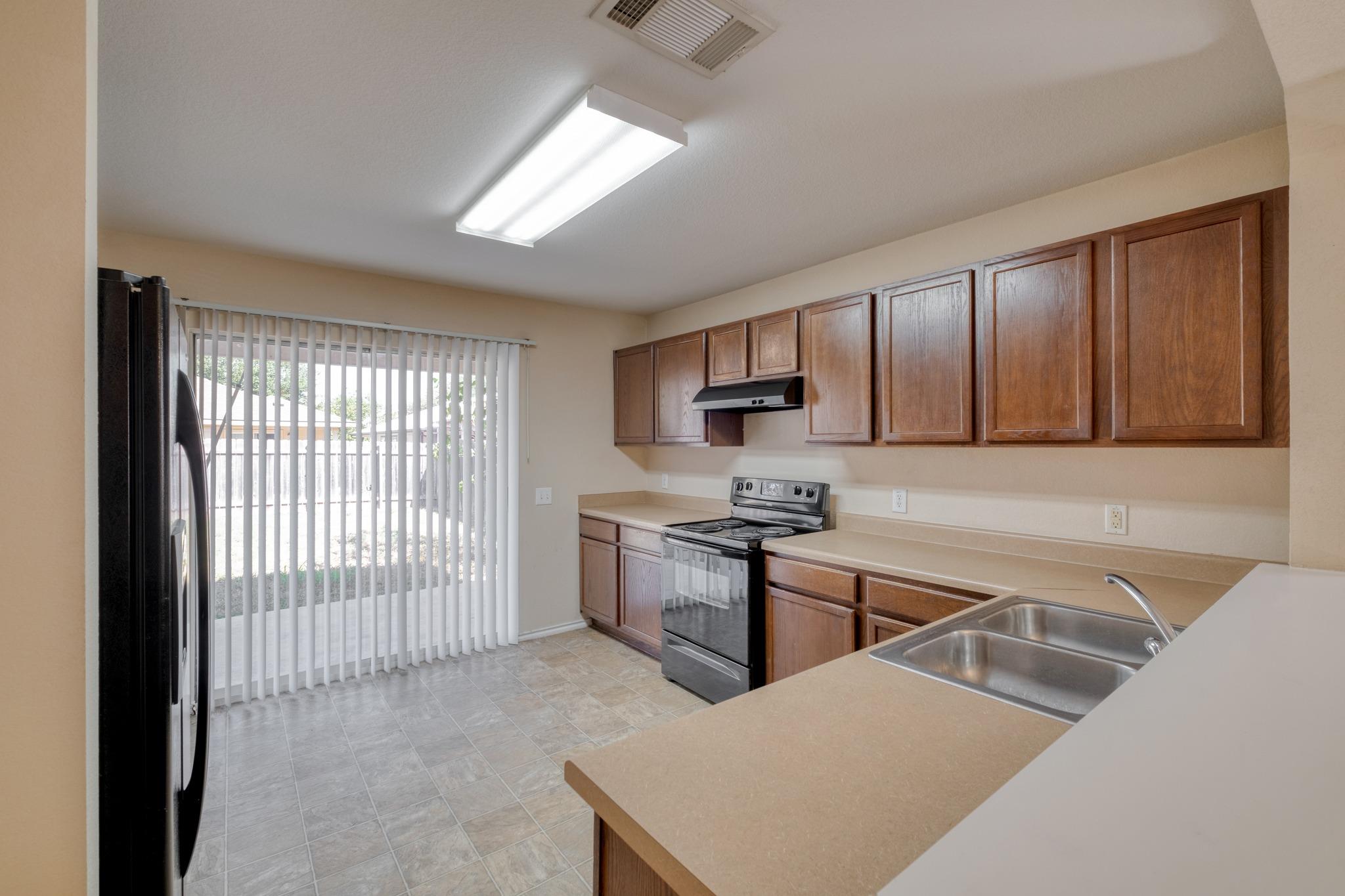 Sliding glass doors open from the kitchen onto th