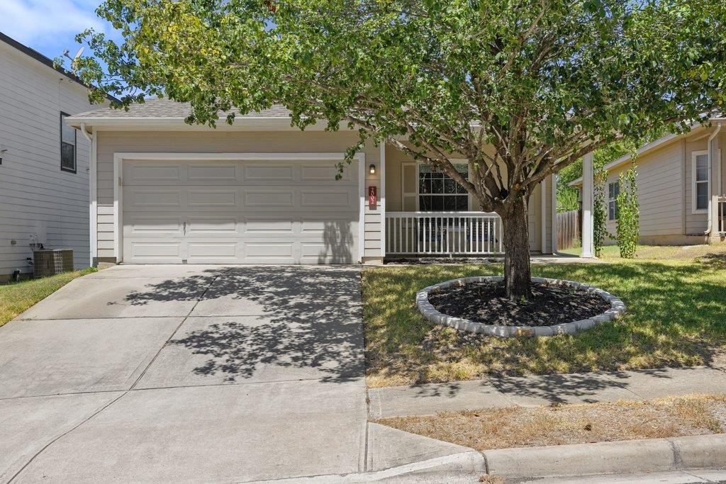 Mature trees frame a welcoming front porch and a 