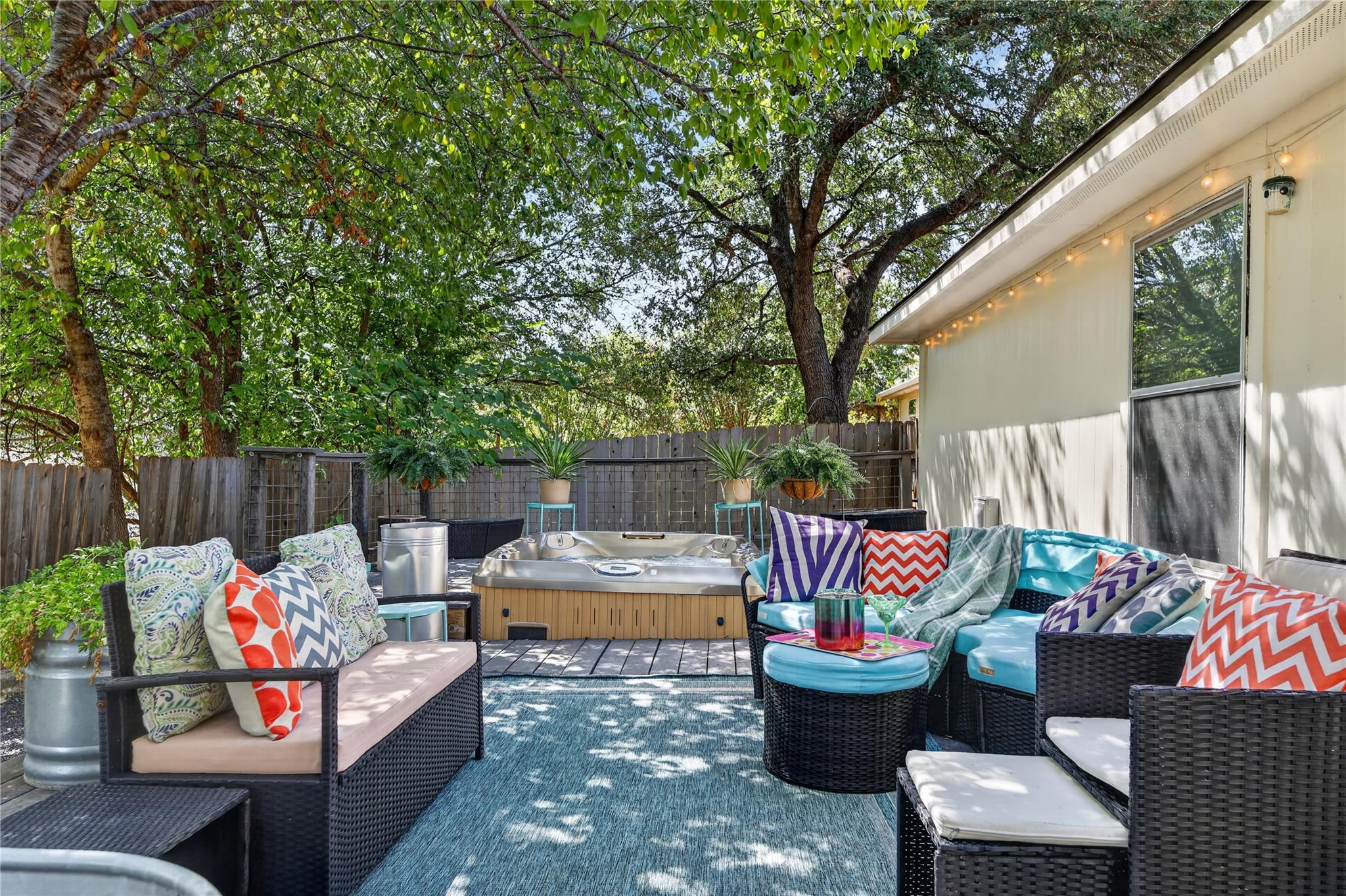 Mature trees shade a private backyard patio compl