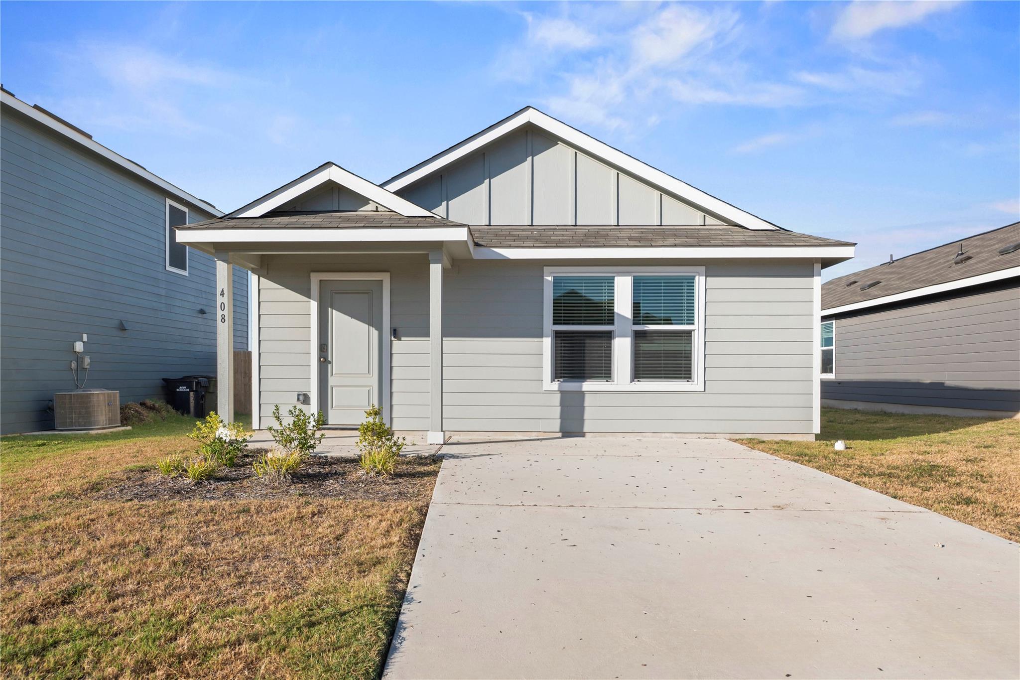 Crisp gables and horizontal siding frame a welcom