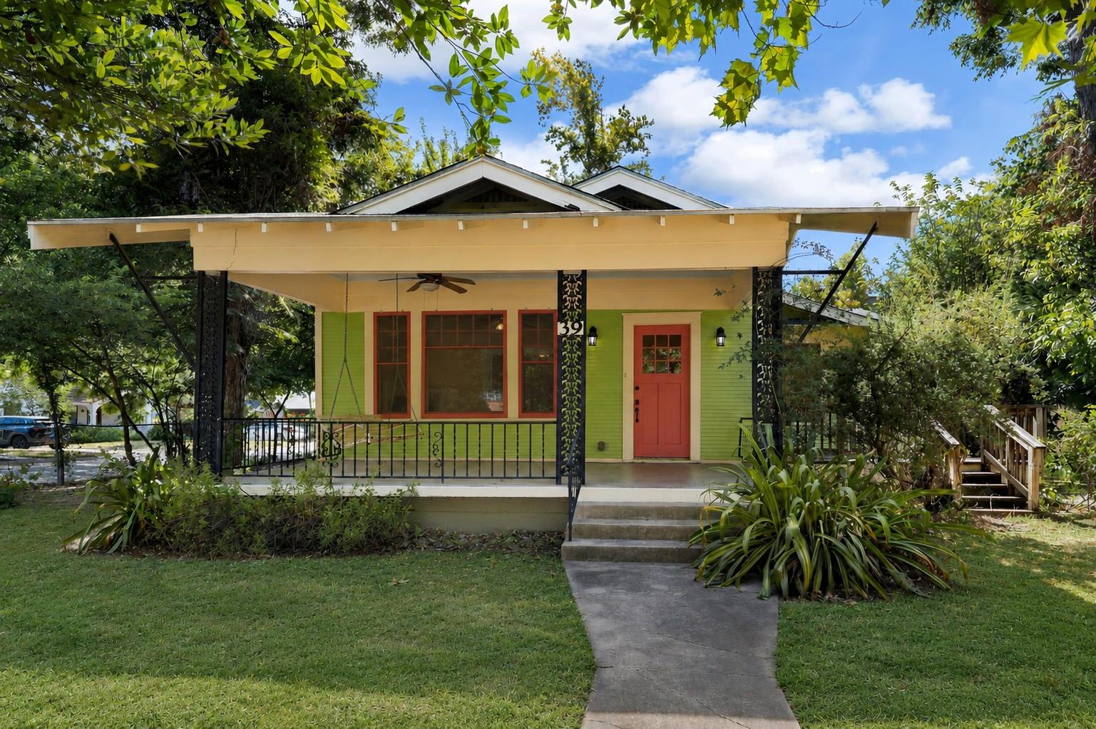 An inviting front porch with classic columns anch