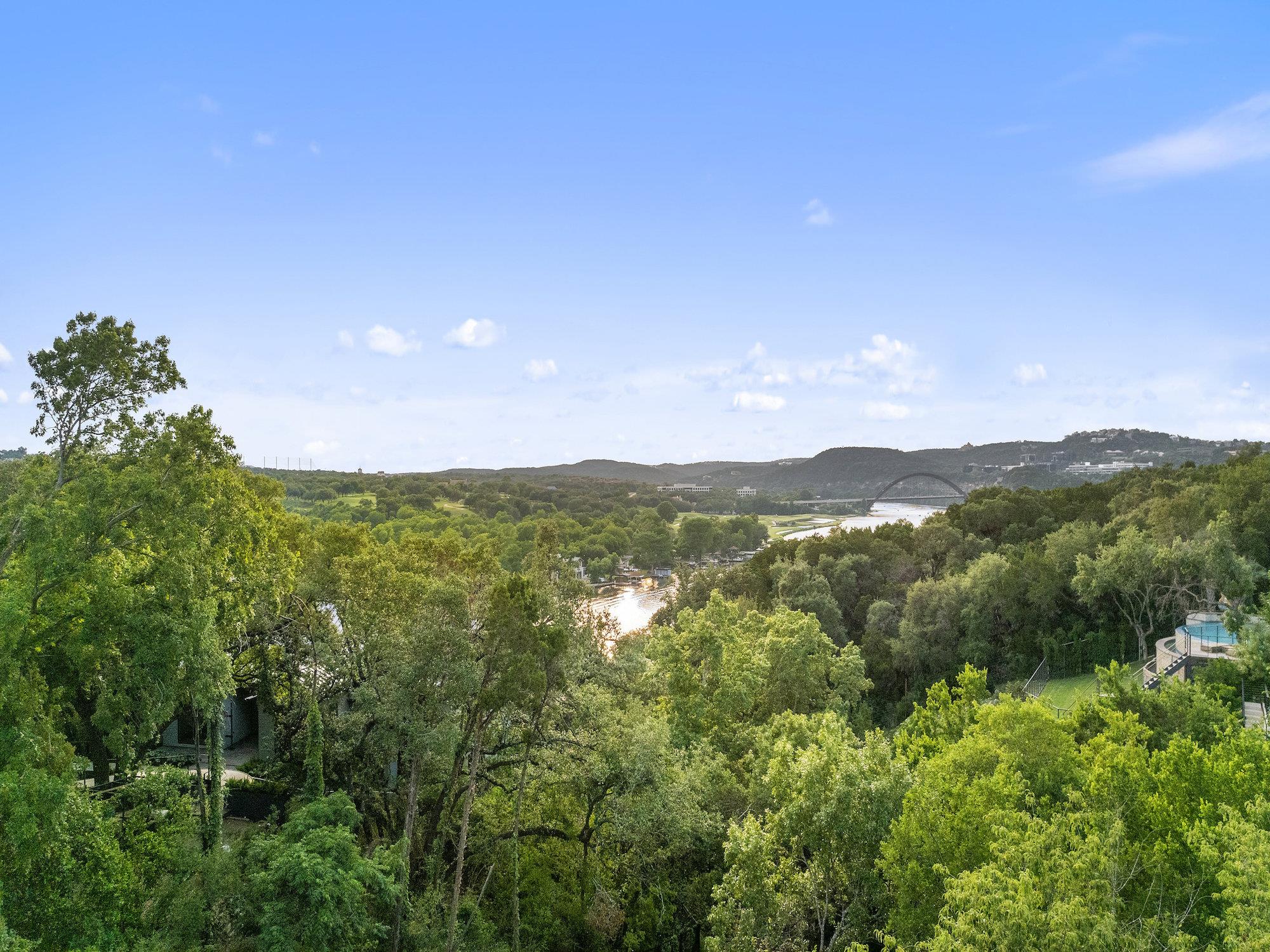 Lush tree canopies frame long-range views of the 