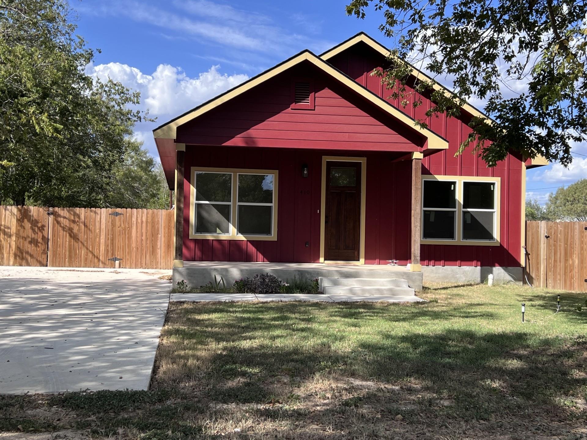 Board and batten siding meets warm wood trim unde