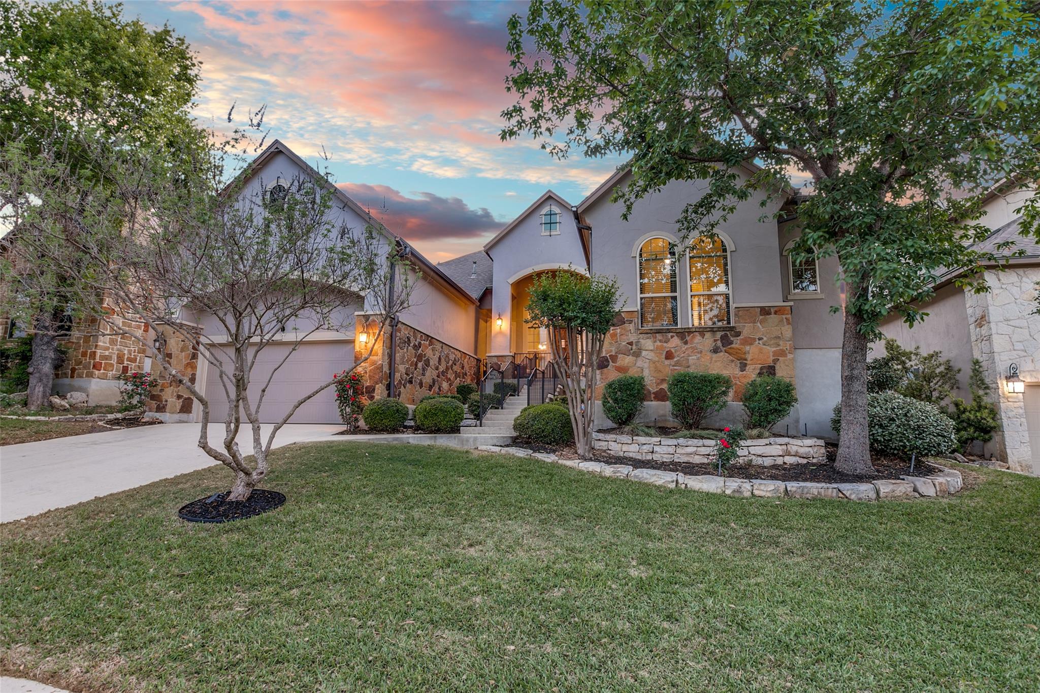 Stately stone and stucco exterior elements define