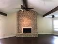 A floor-to-ceiling stone fireplace serves as the 