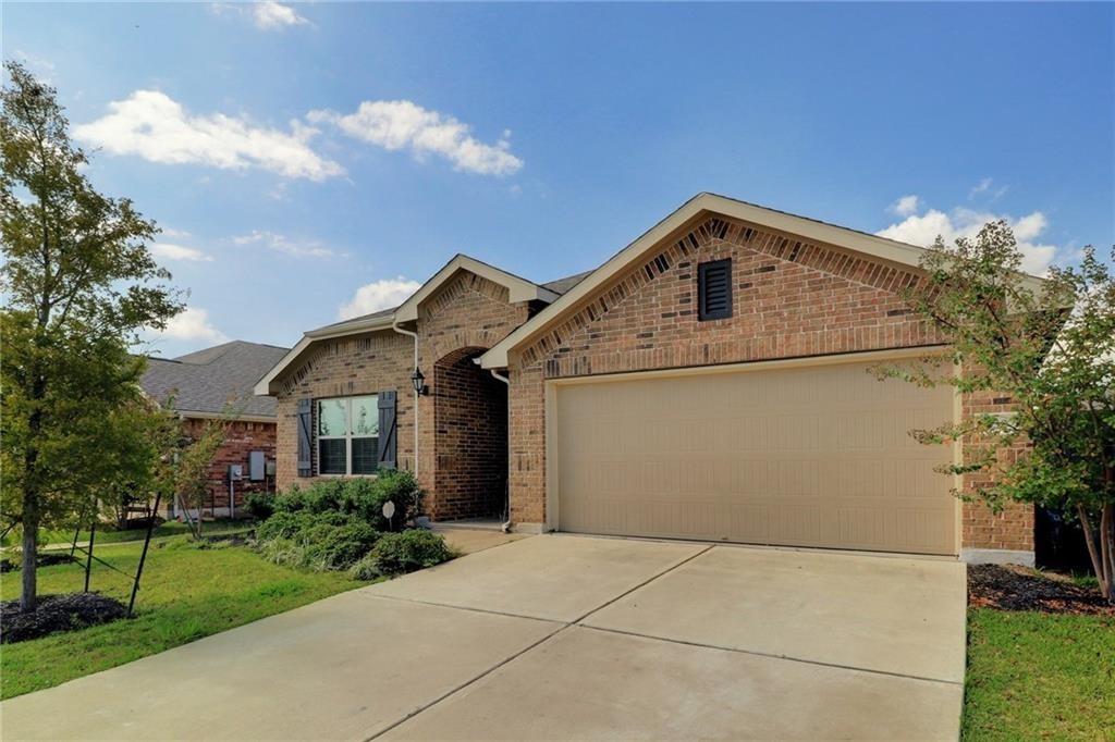A classic brick exterior and a concrete driveway 