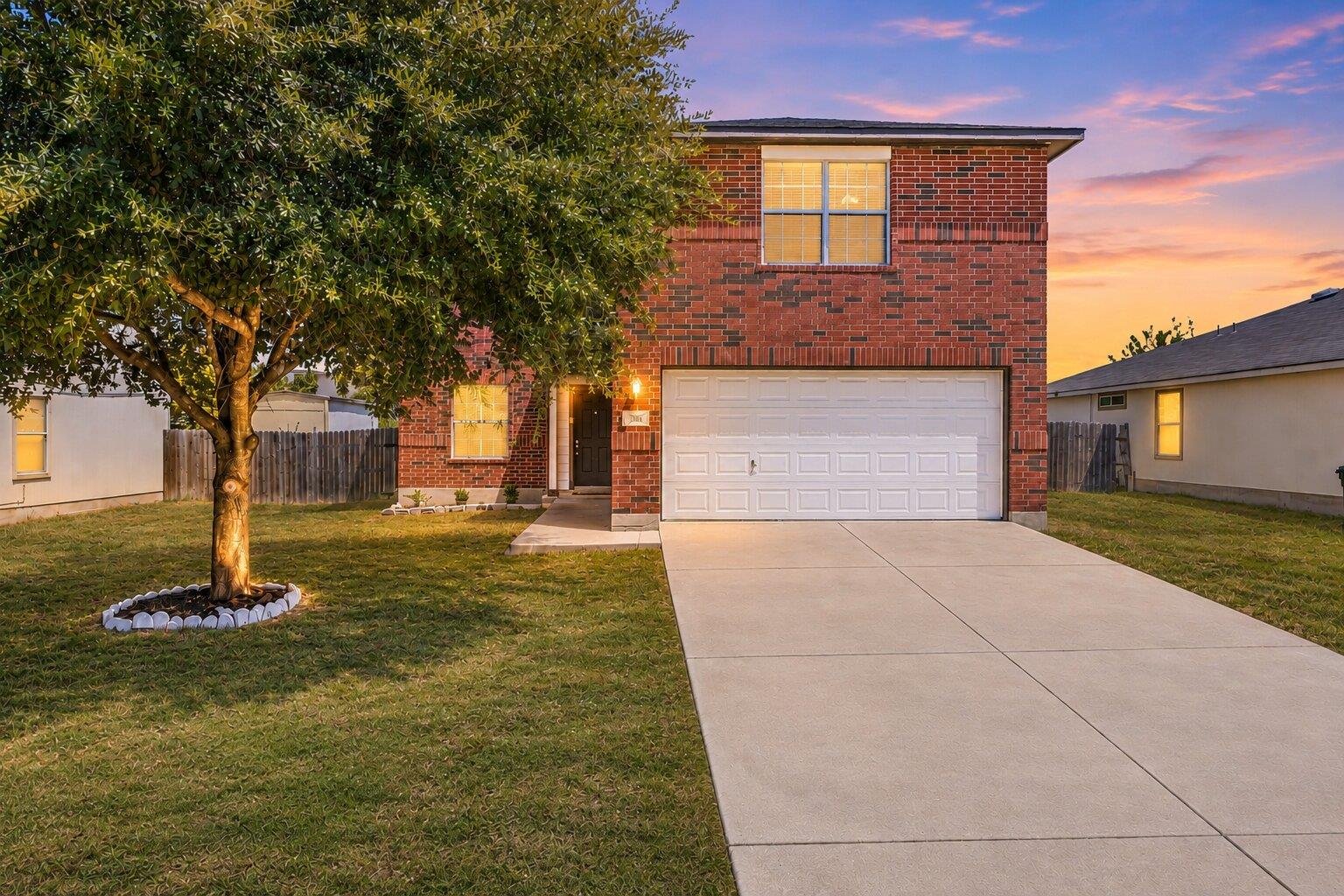 Classic brick exterior accents this two-story hom