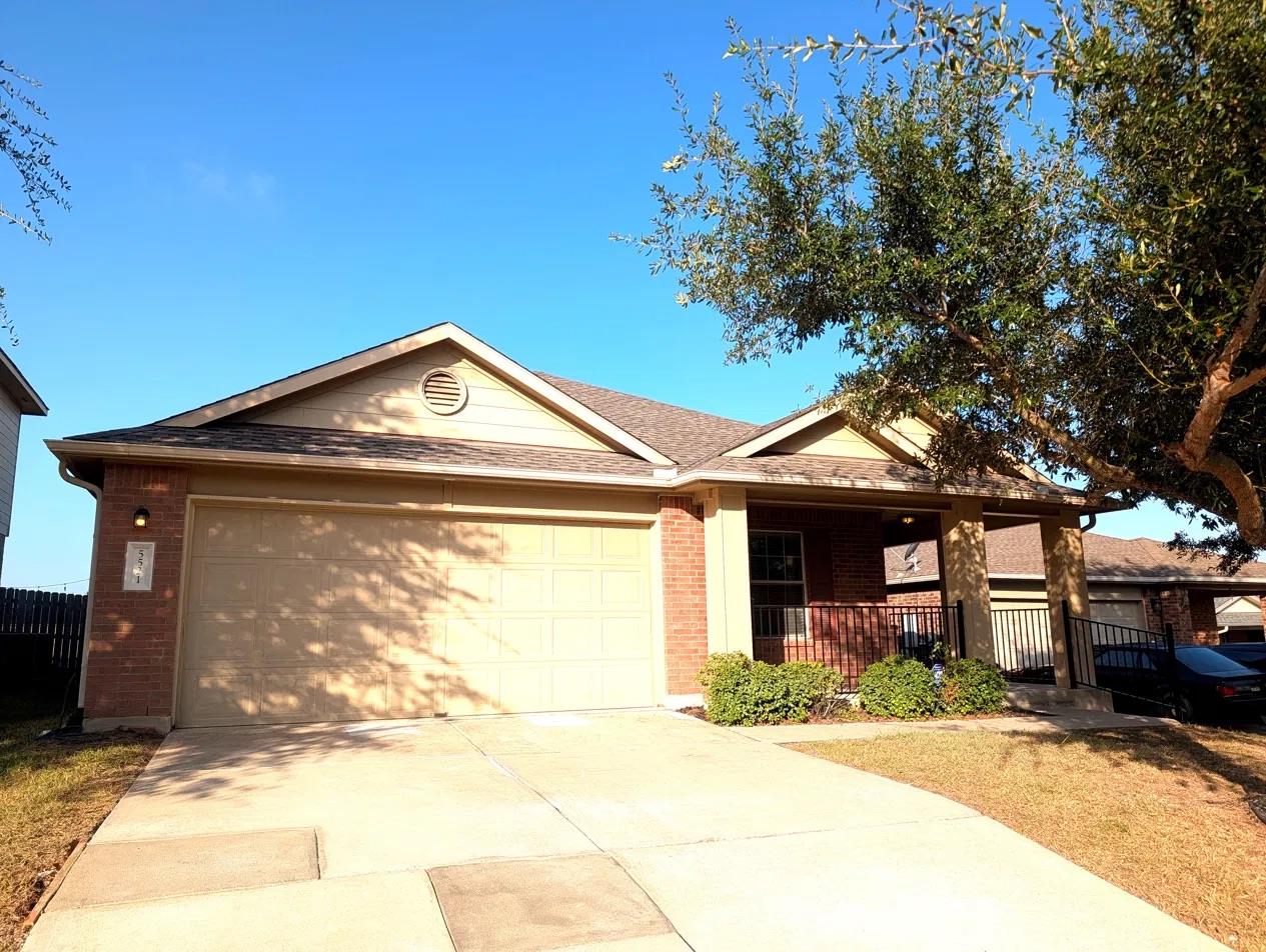 Classic brick accents and a spacious concrete dri