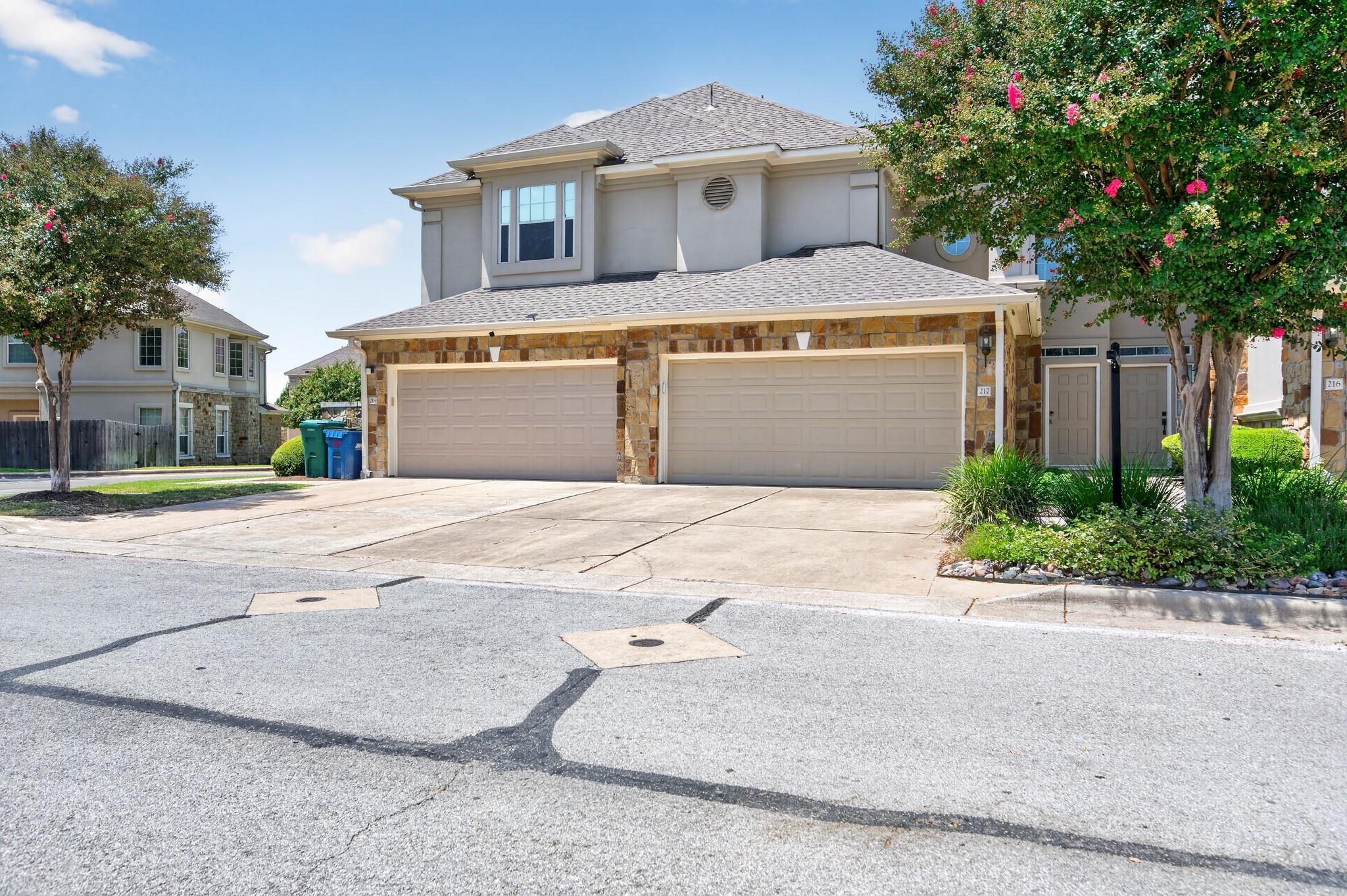 Stone accents and a multi-car garage define this 