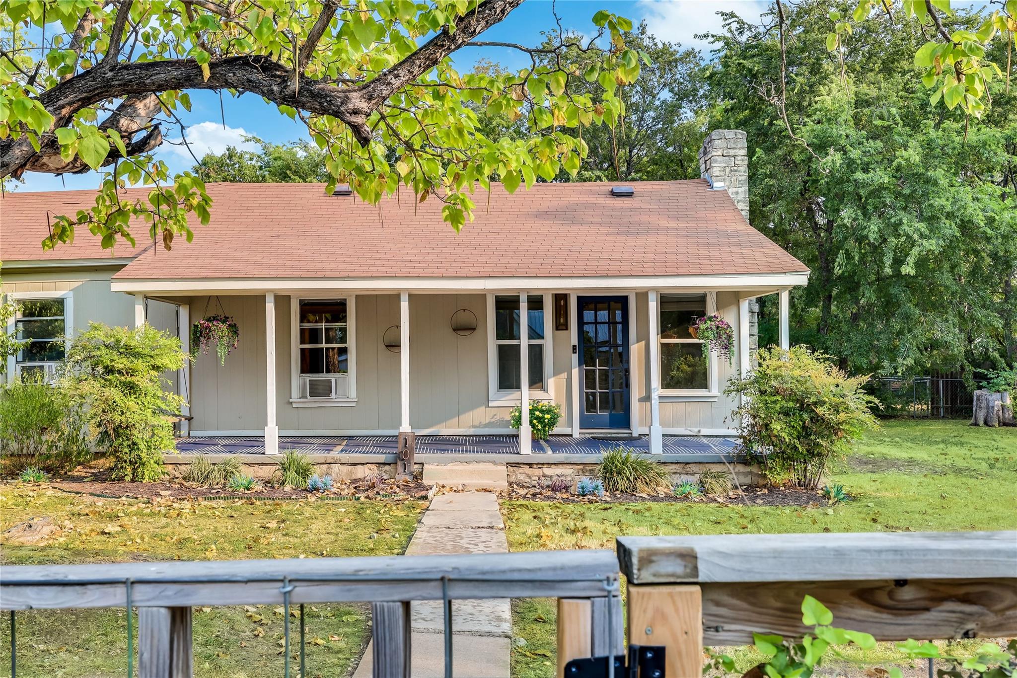 A welcoming front porch with classic columns stre