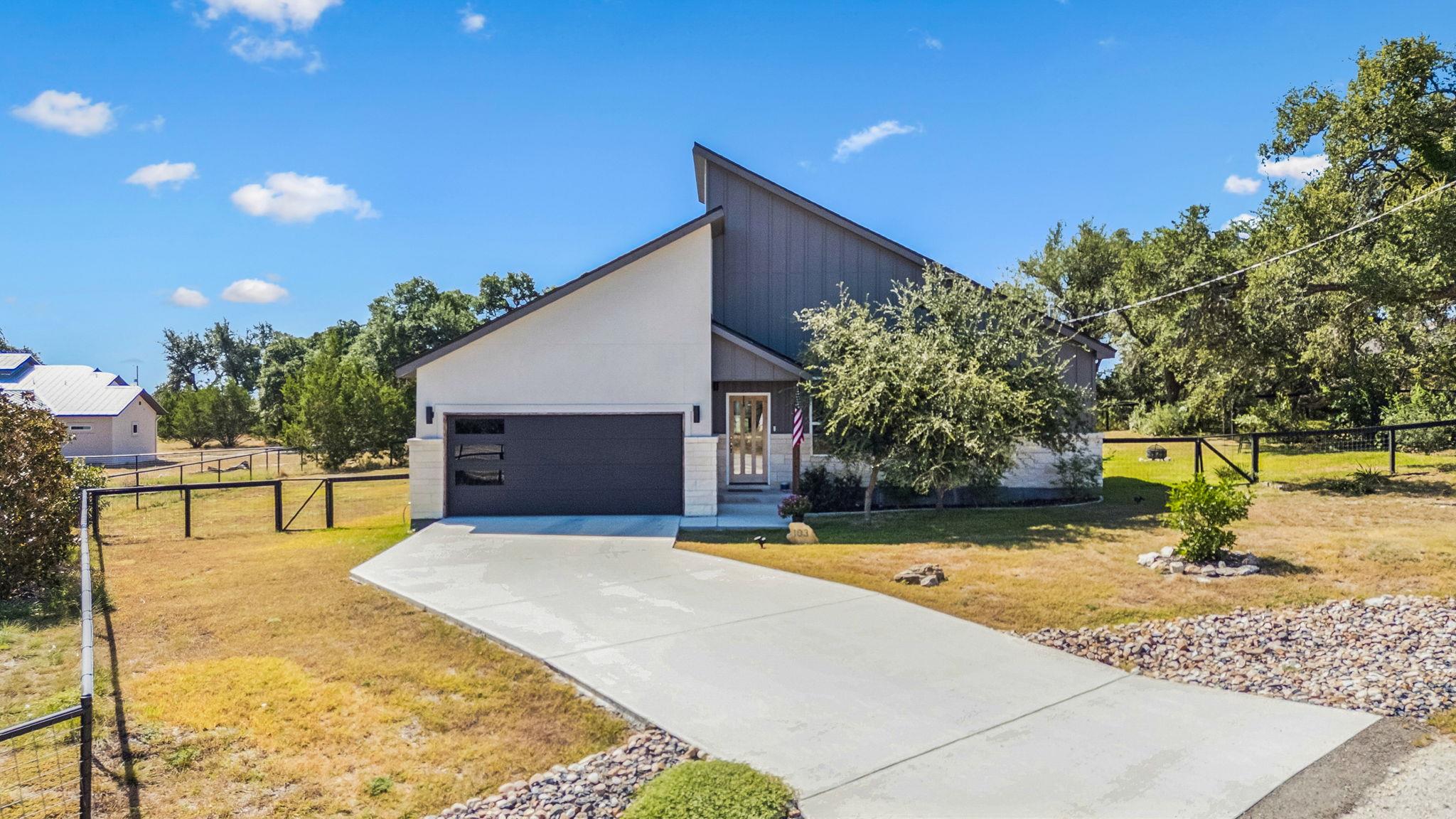 Bold geometric rooflines and a concrete driveway 
