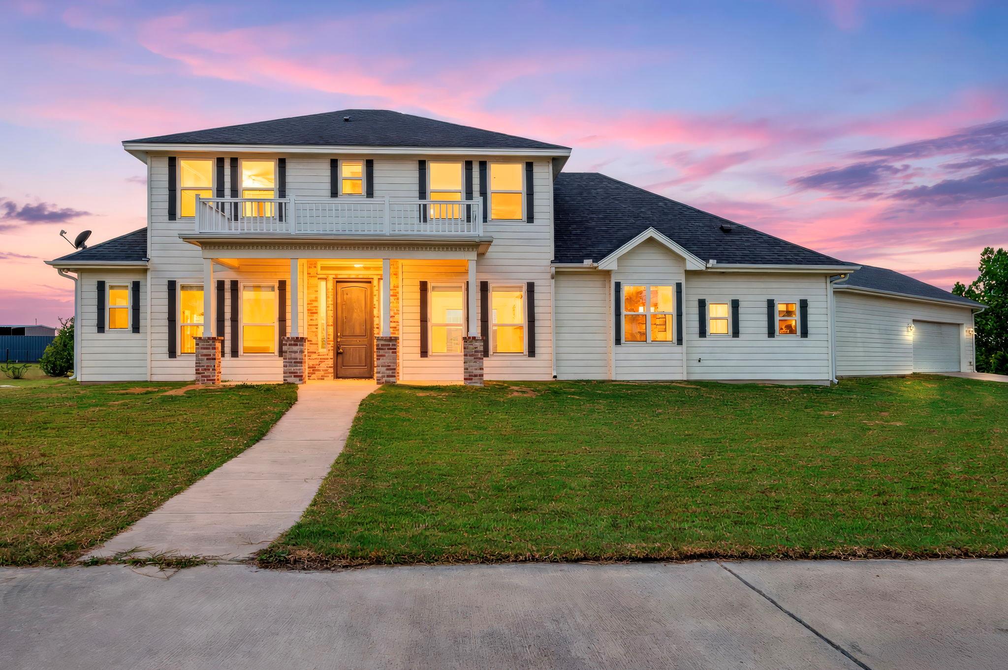 A classic two-story exterior showcases a wide fro