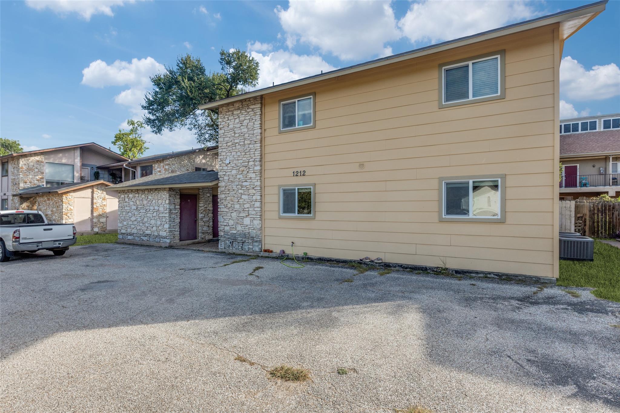 A classic exterior clad in siding and stone accen
