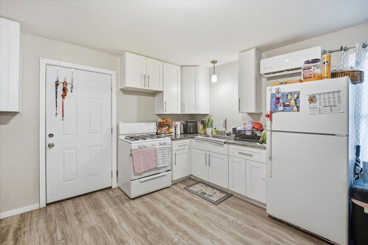White cabinetry paired with durable wood-look flo
