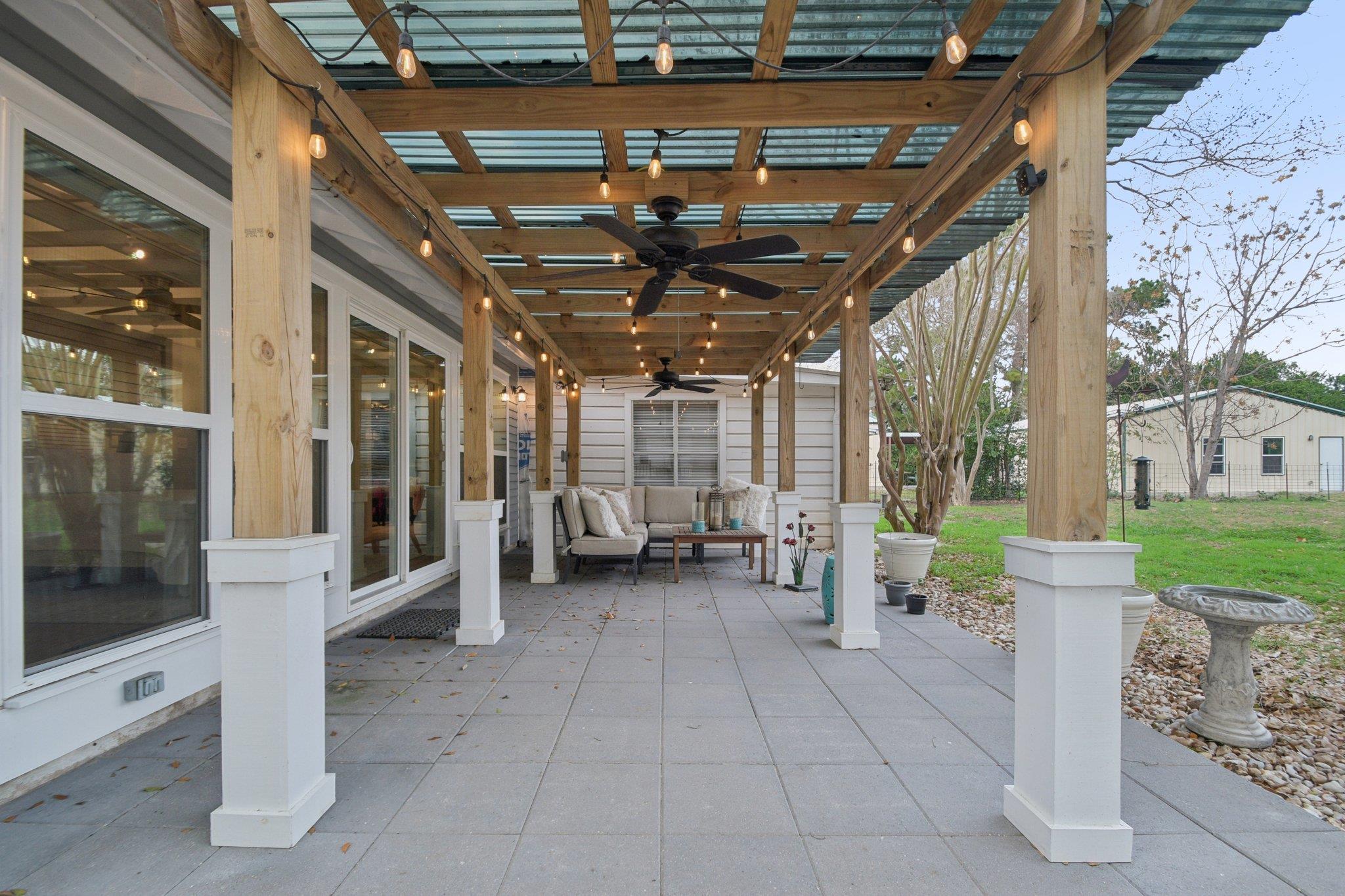 View of patio featuring a ceiling fan and an outd