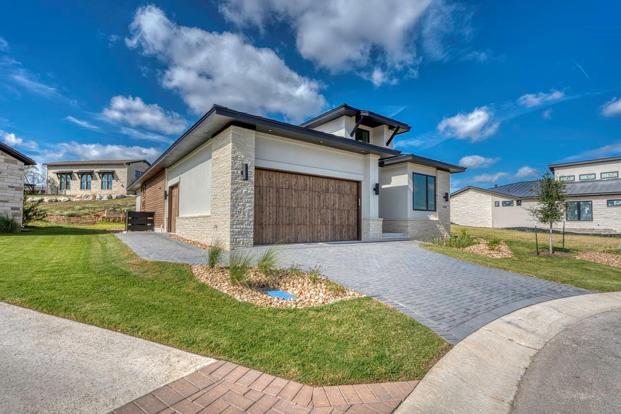 Textured stone veneer accents the exterior facade