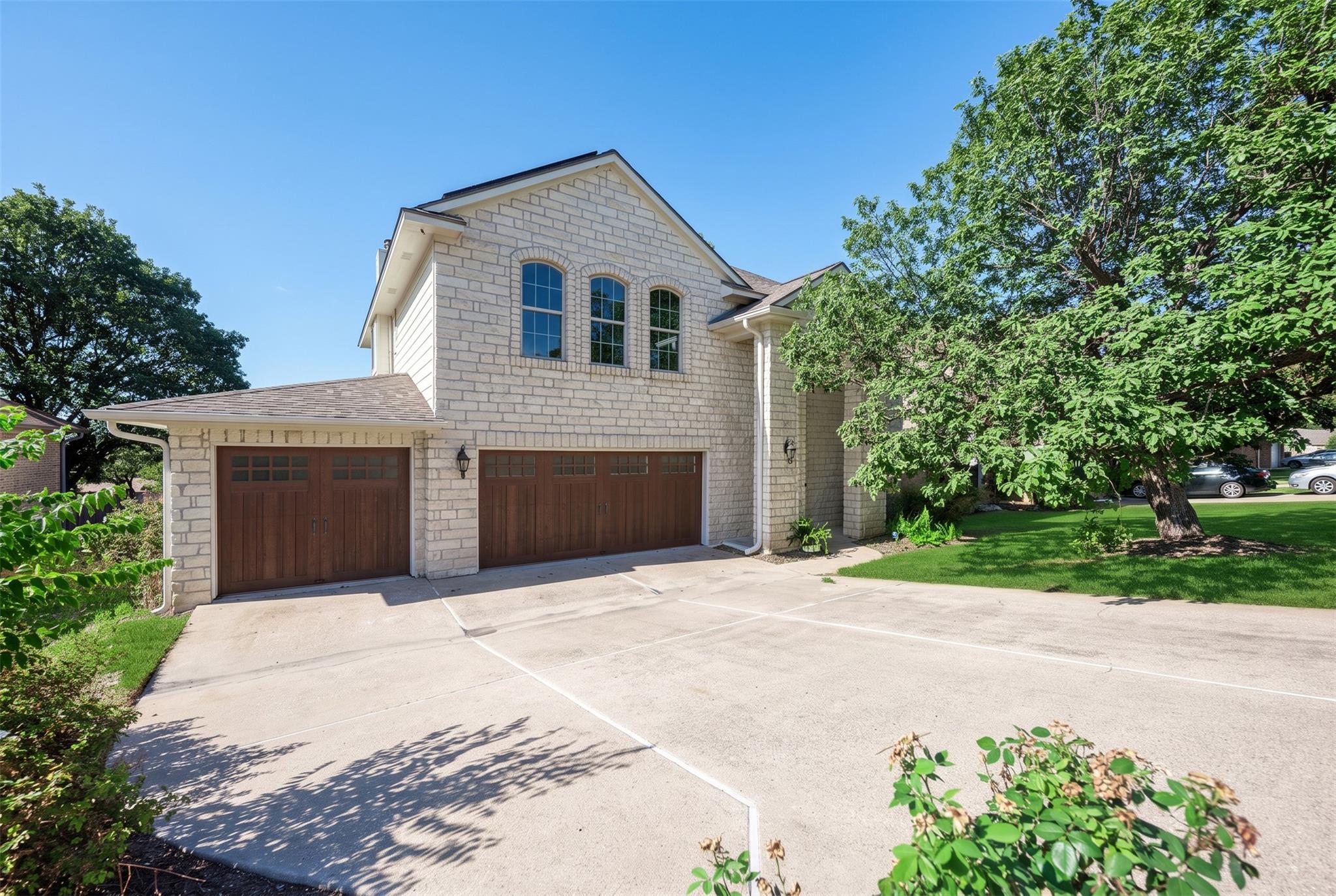 Arched windows and natural stone siding complemen