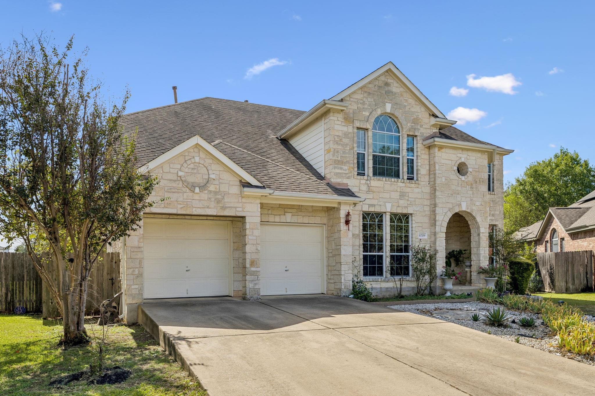 A classic stone facade with arched entry details 