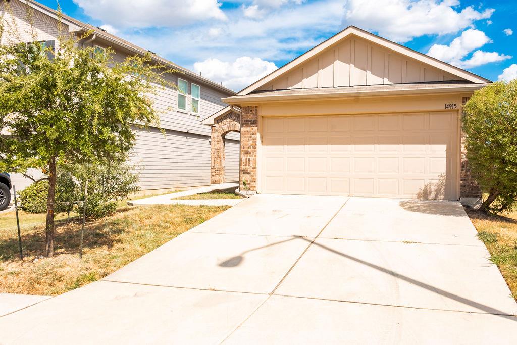 A concrete driveway leads to the front-facing two