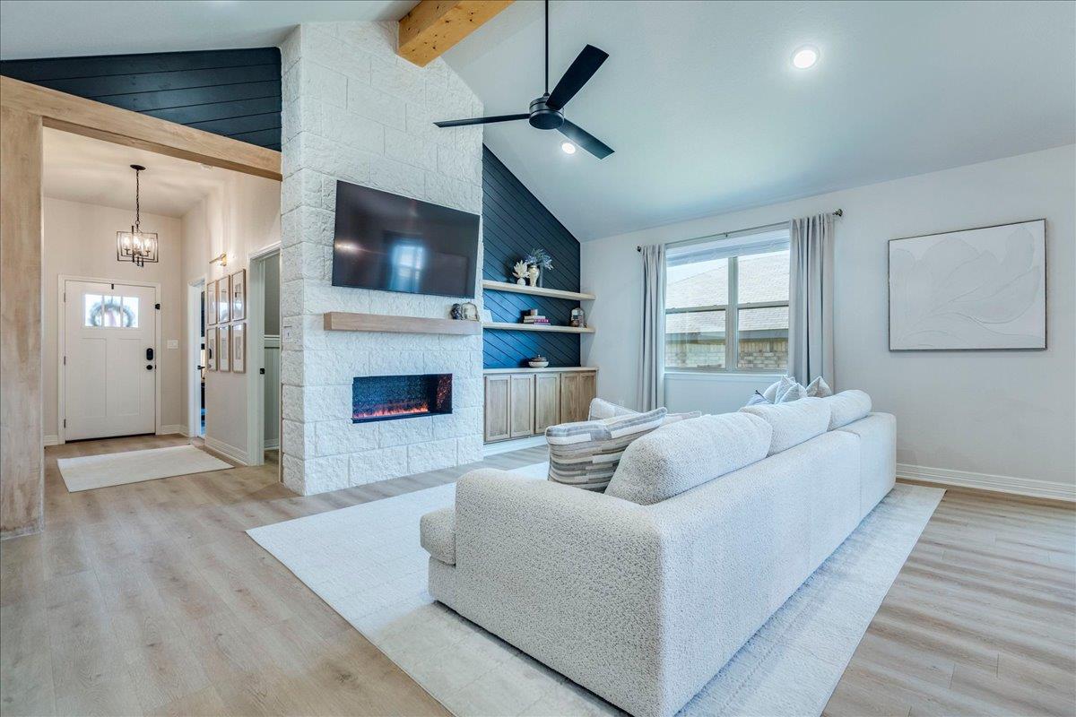 Vaulted ceilings and a stone fireplace define thi