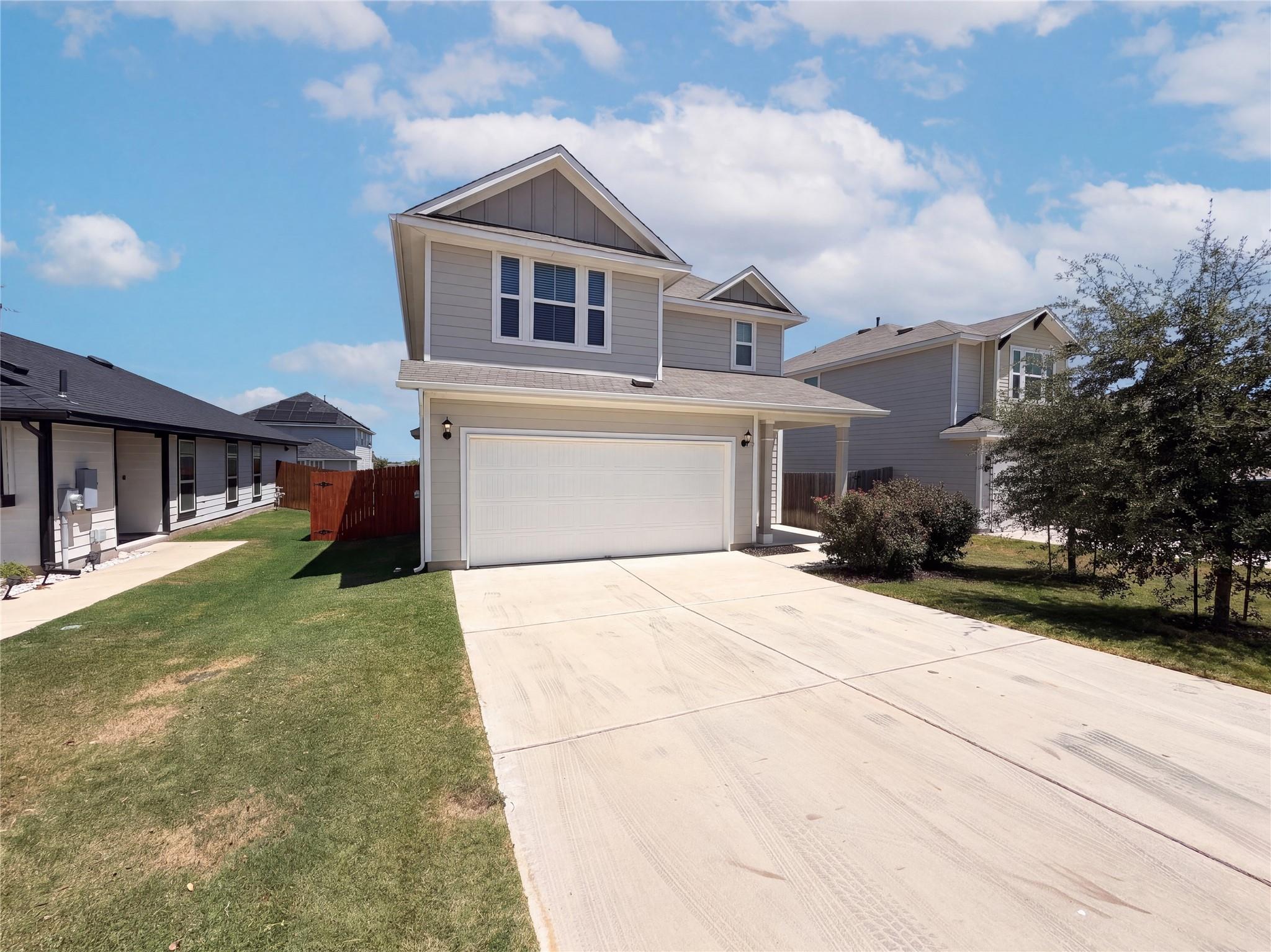 An inviting exterior with a spacious concrete dri