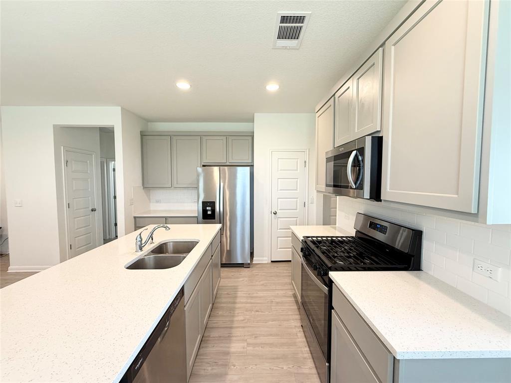 Elegant quartz countertops and recessed lighting 