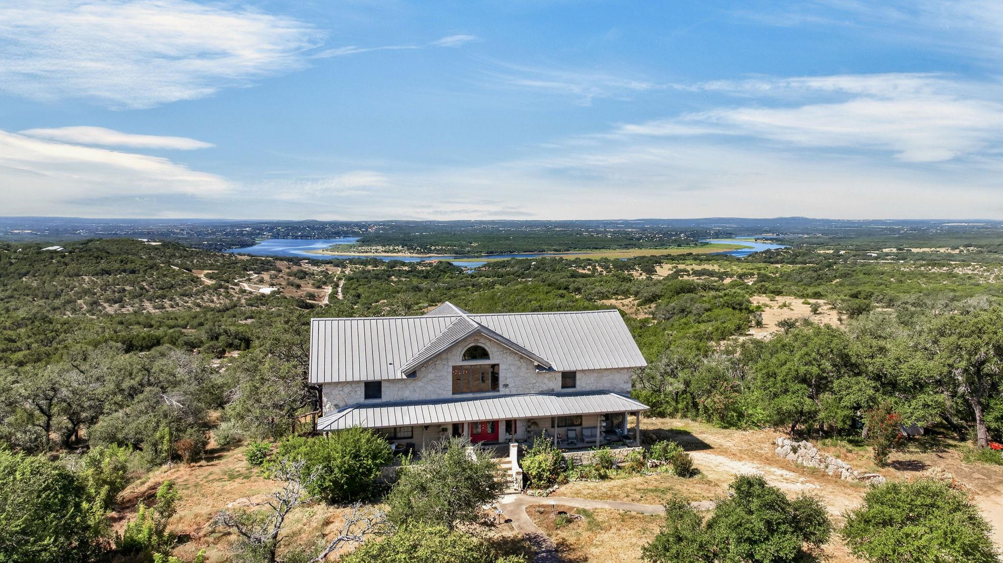 Metal roofing and stone siding define this hillsi