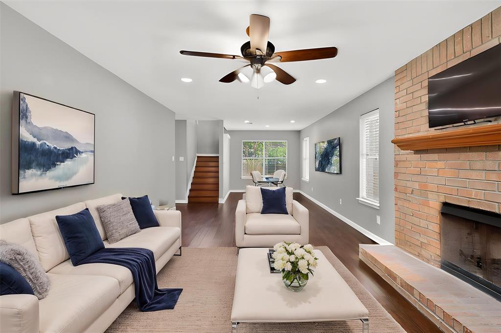 Gleaming hardwood floors run through a light-fill