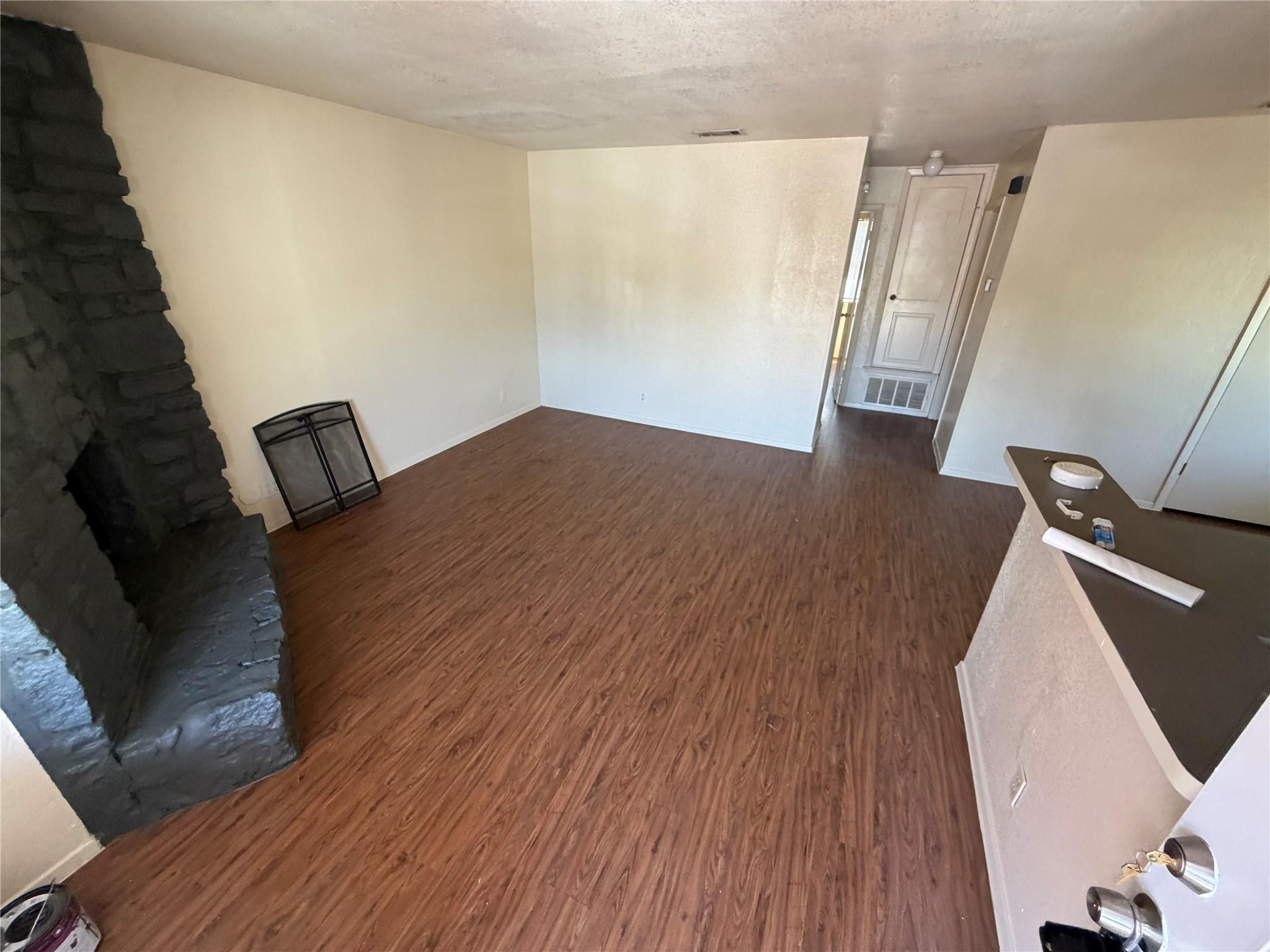 Rich wood-look flooring anchors this open living 