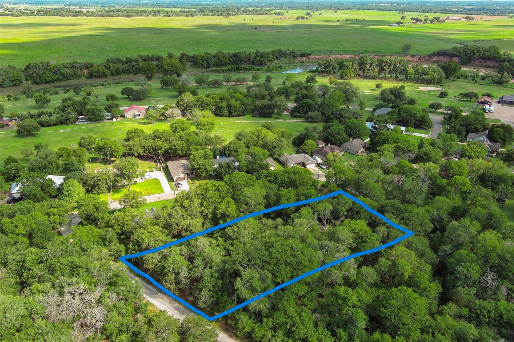 Mature trees blanket a generous home site nestled