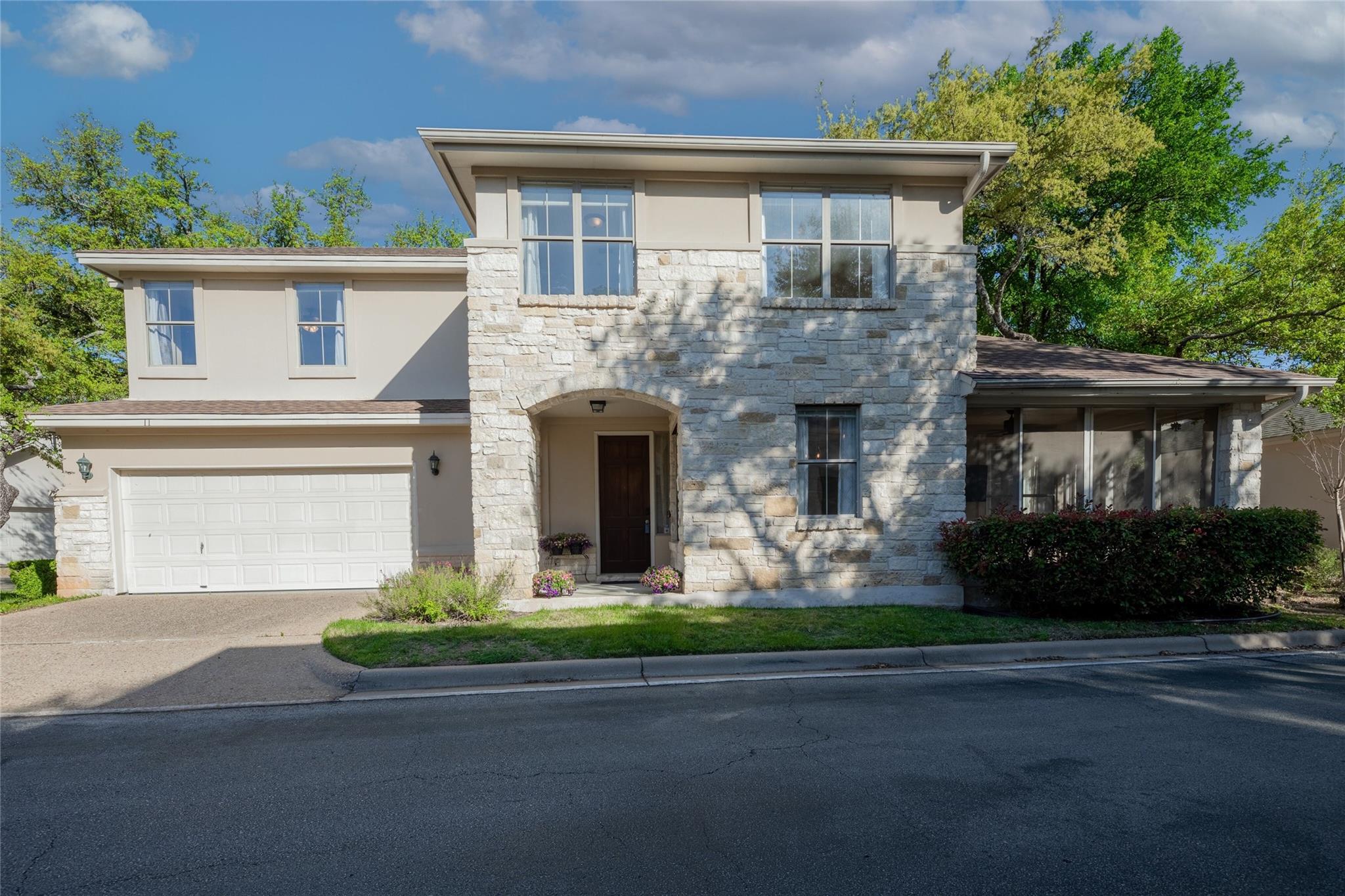 Natural stone and smooth stucco define the exteri