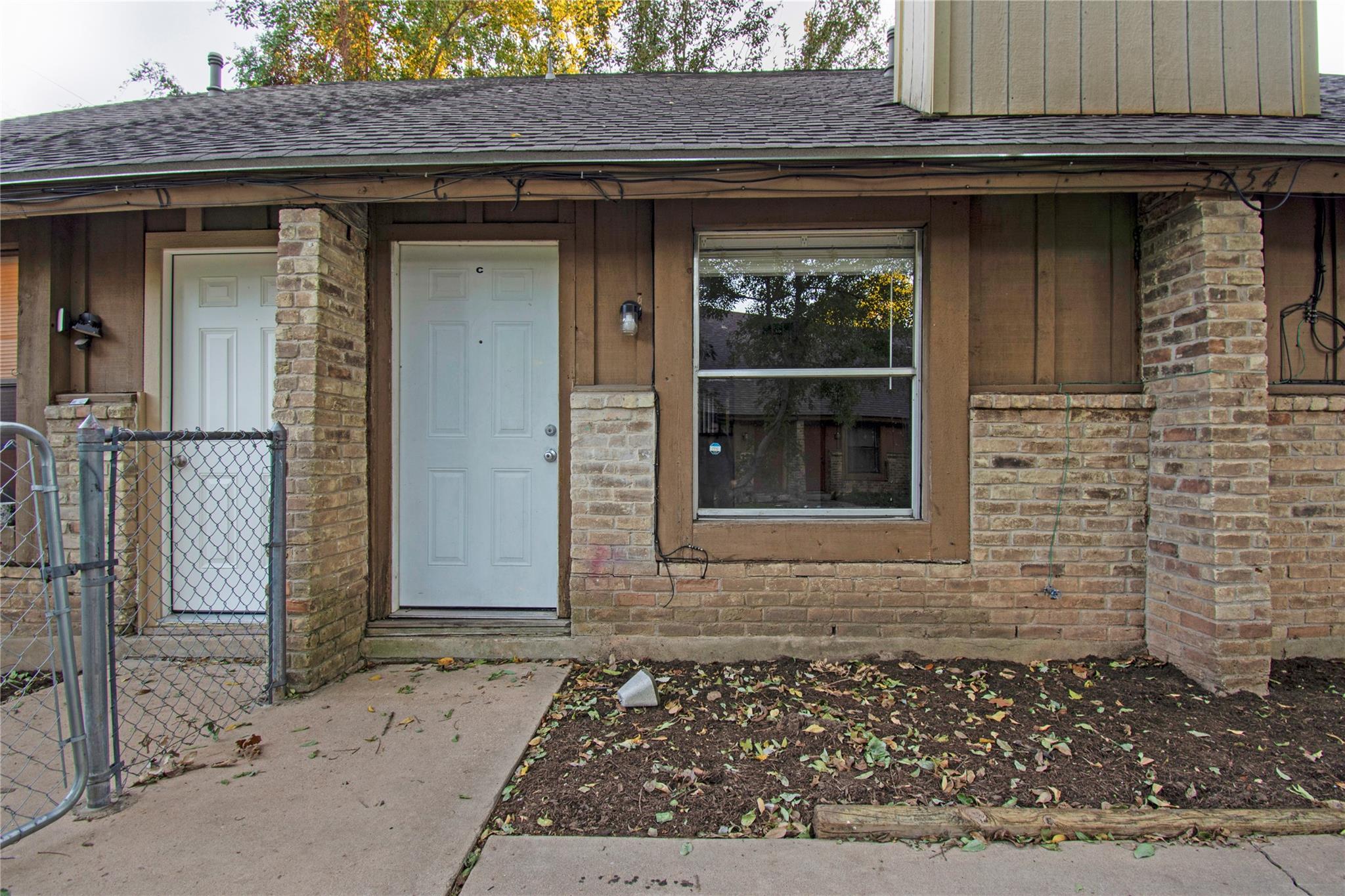Brick accents and wood siding define the architec