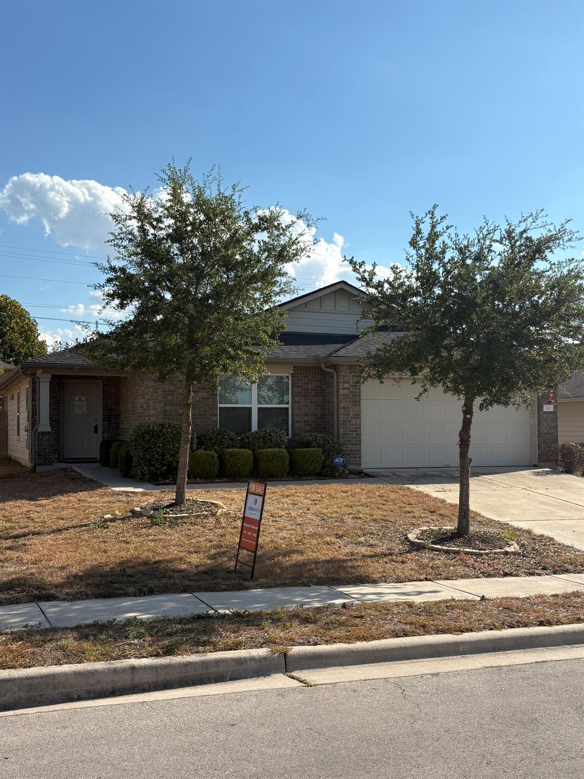 Classic brick exterior and an attached garage est