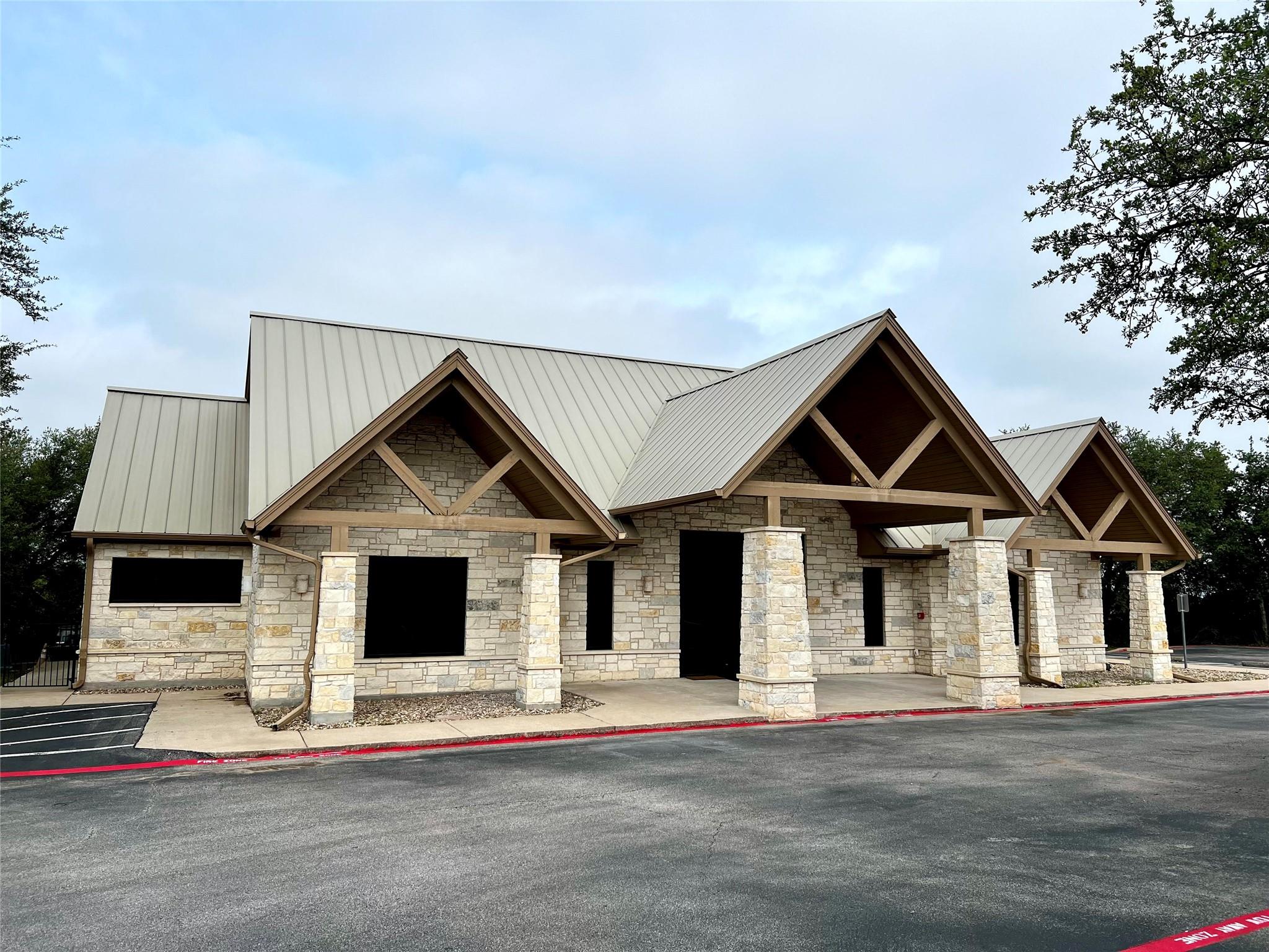 Custom stone masonry and exposed timber gables fr