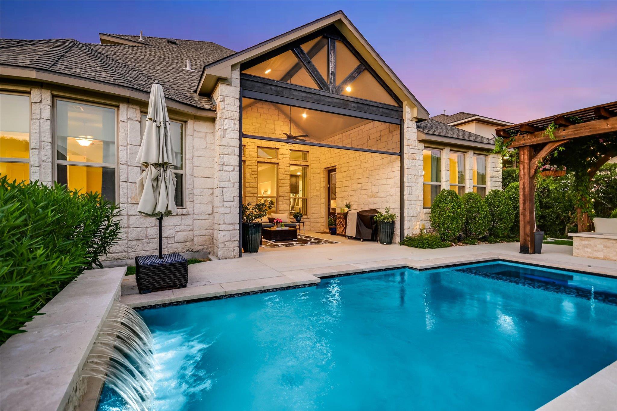 An inviting backyard oasis centers around a custo