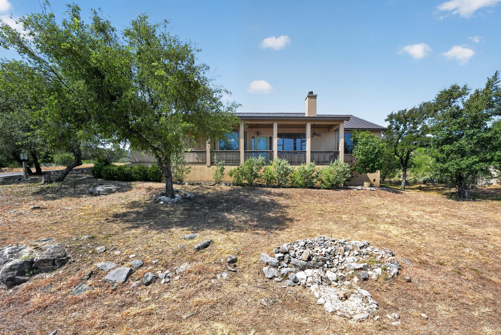 Nestled among mature trees, this one-story home f