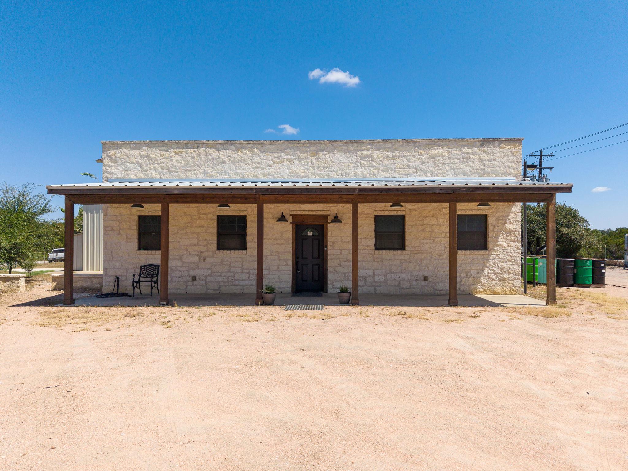 Rustic stone exterior walls support a broad cover