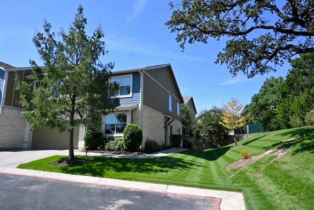 Manicured green lawns surround a modern multi-sto