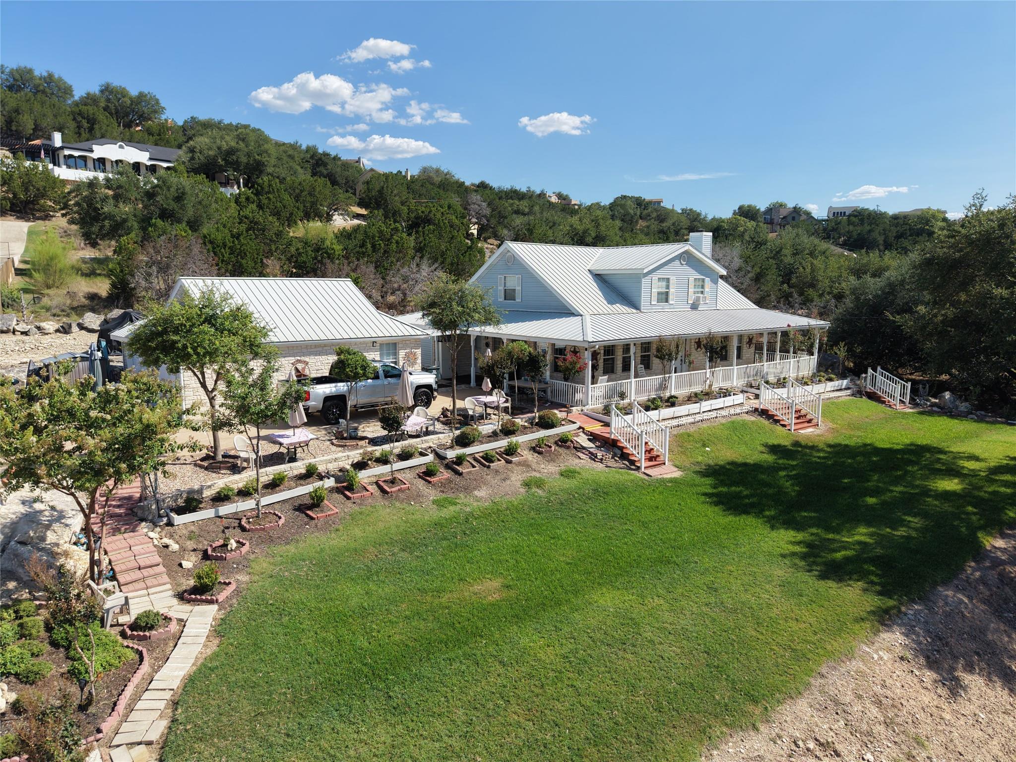 Metal roofing and a deep wraparound porch anchor 