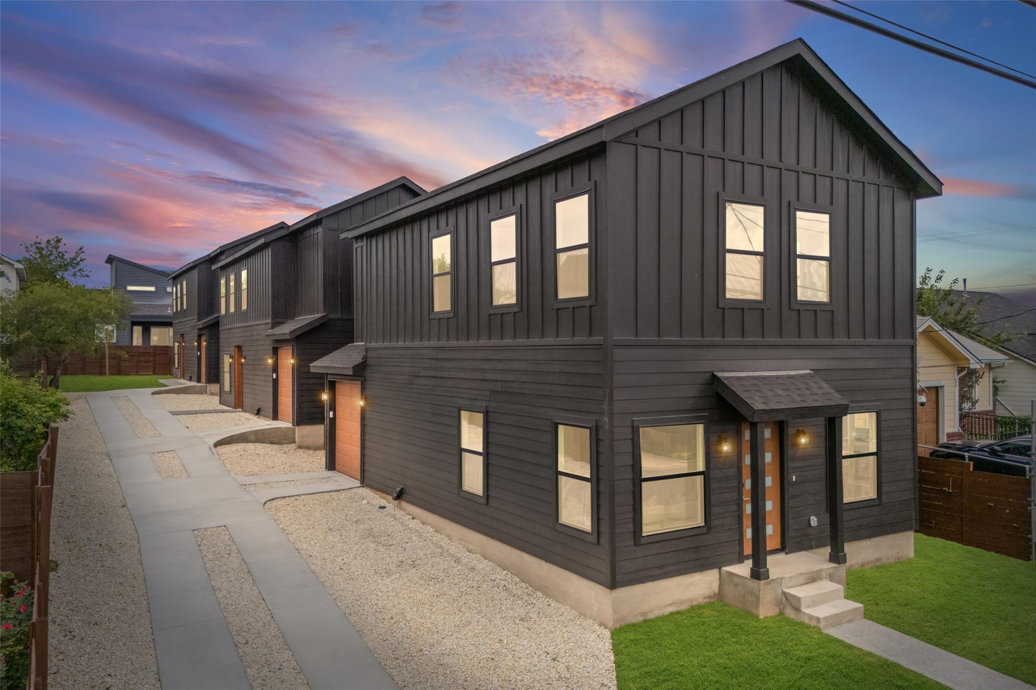 Bold dark vertical siding and a matching gabled r