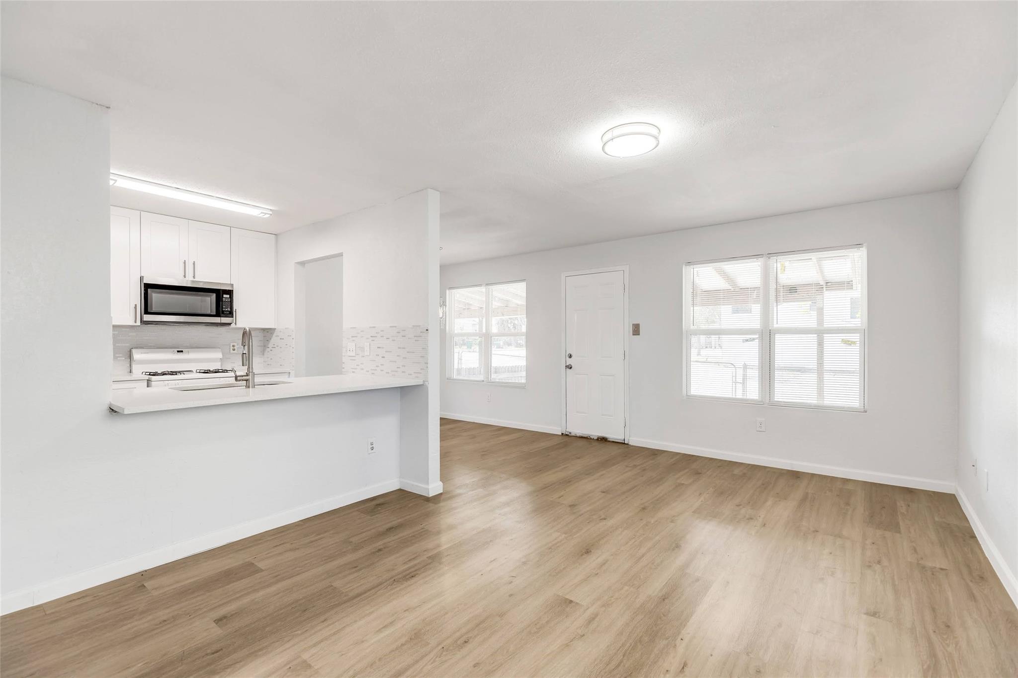 Smooth wood-look flooring and a half-wall cutout 