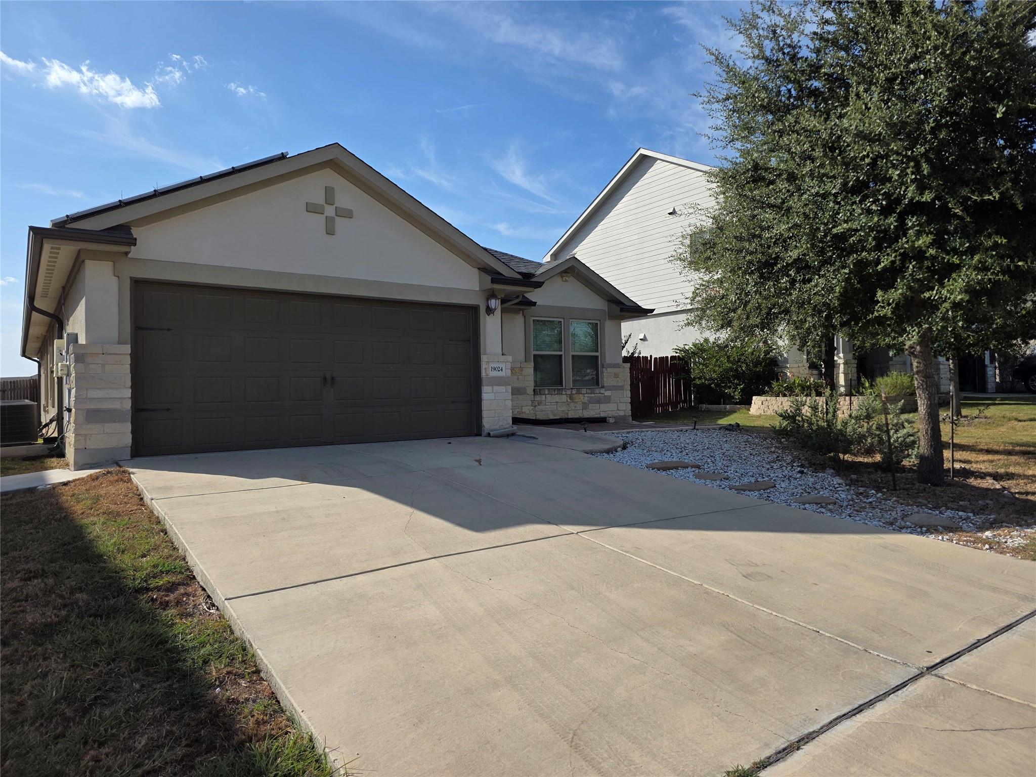An inviting stone and stucco exterior features a 
