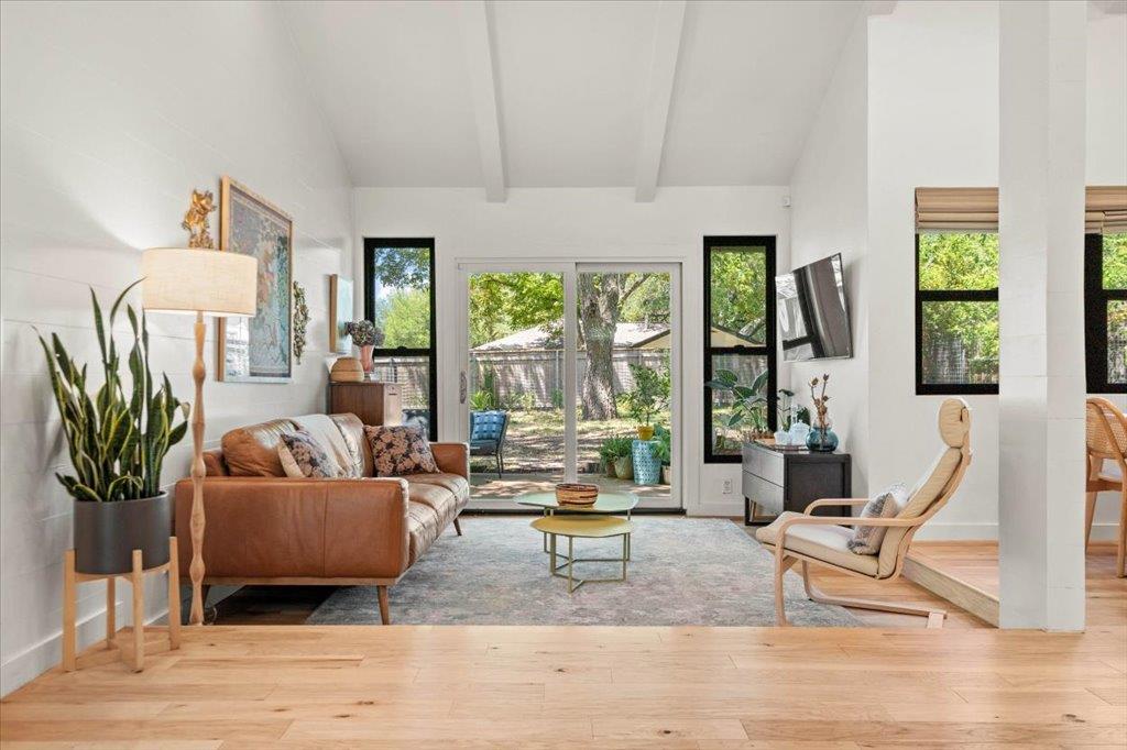 Beamed ceilings and warm wood floors define this 