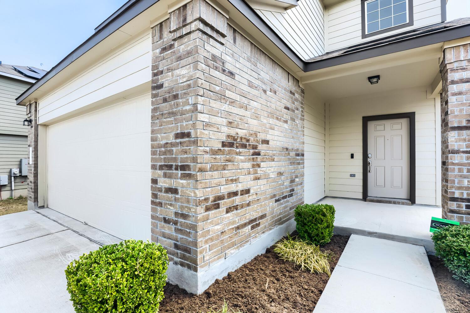 An inviting front entry welcomes visitors with ne