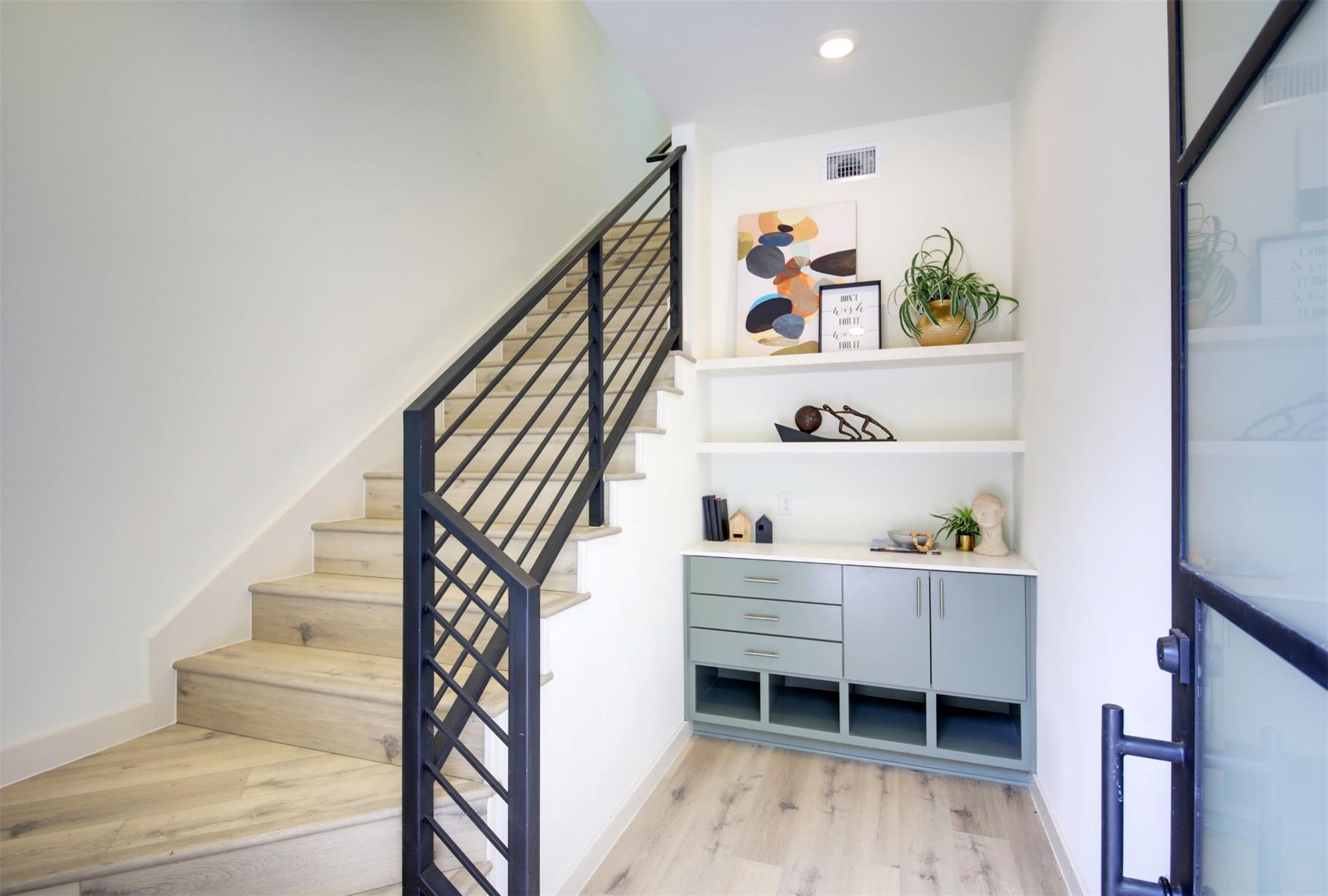 Modern stairs and built-in shelving welcome arriv